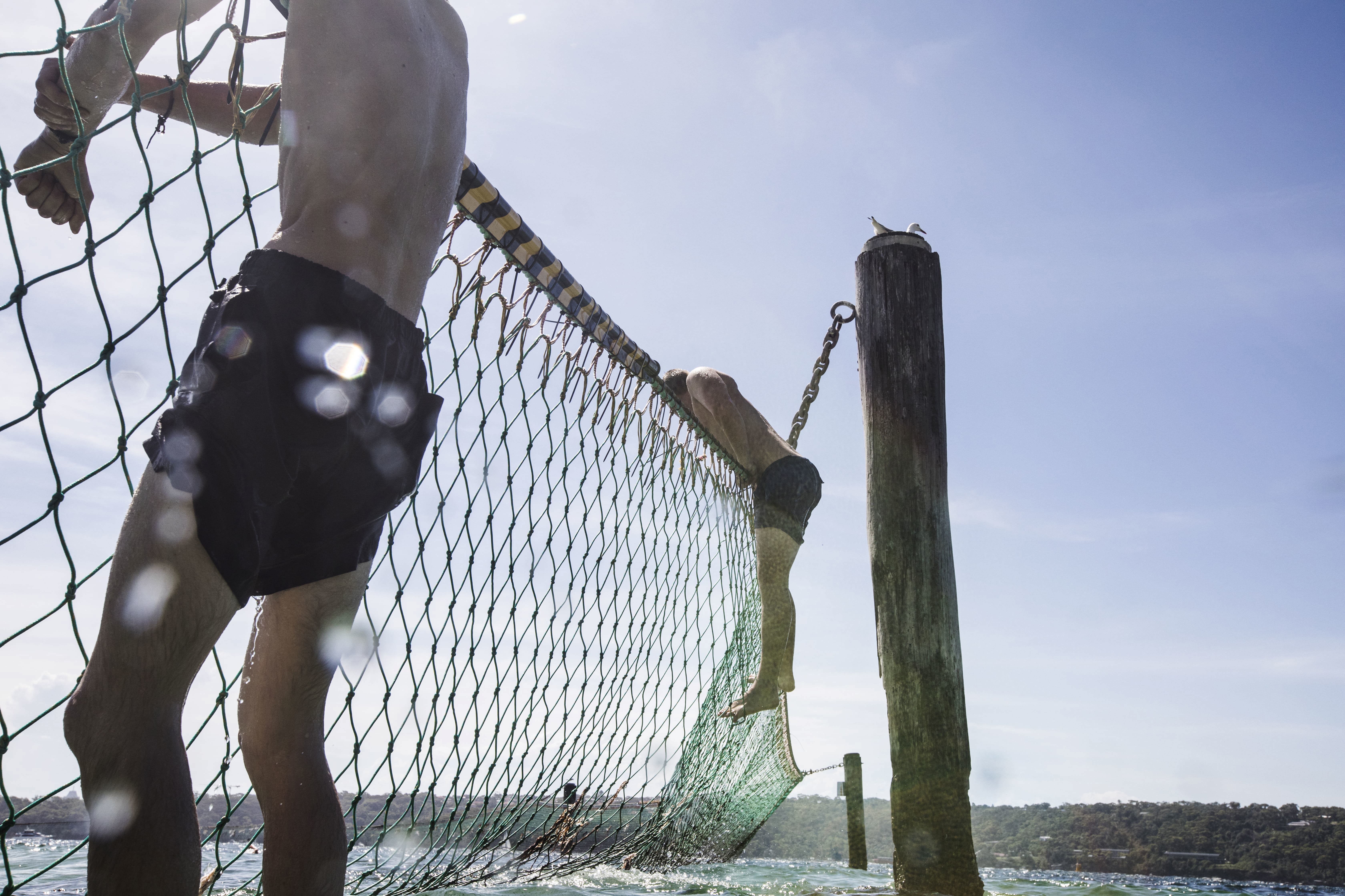 English tourists cool off outside the shark net at Shark Beach, Nielson Park which is one of Sydney's harbour beaches with the cleanest water, on 27 December 2018