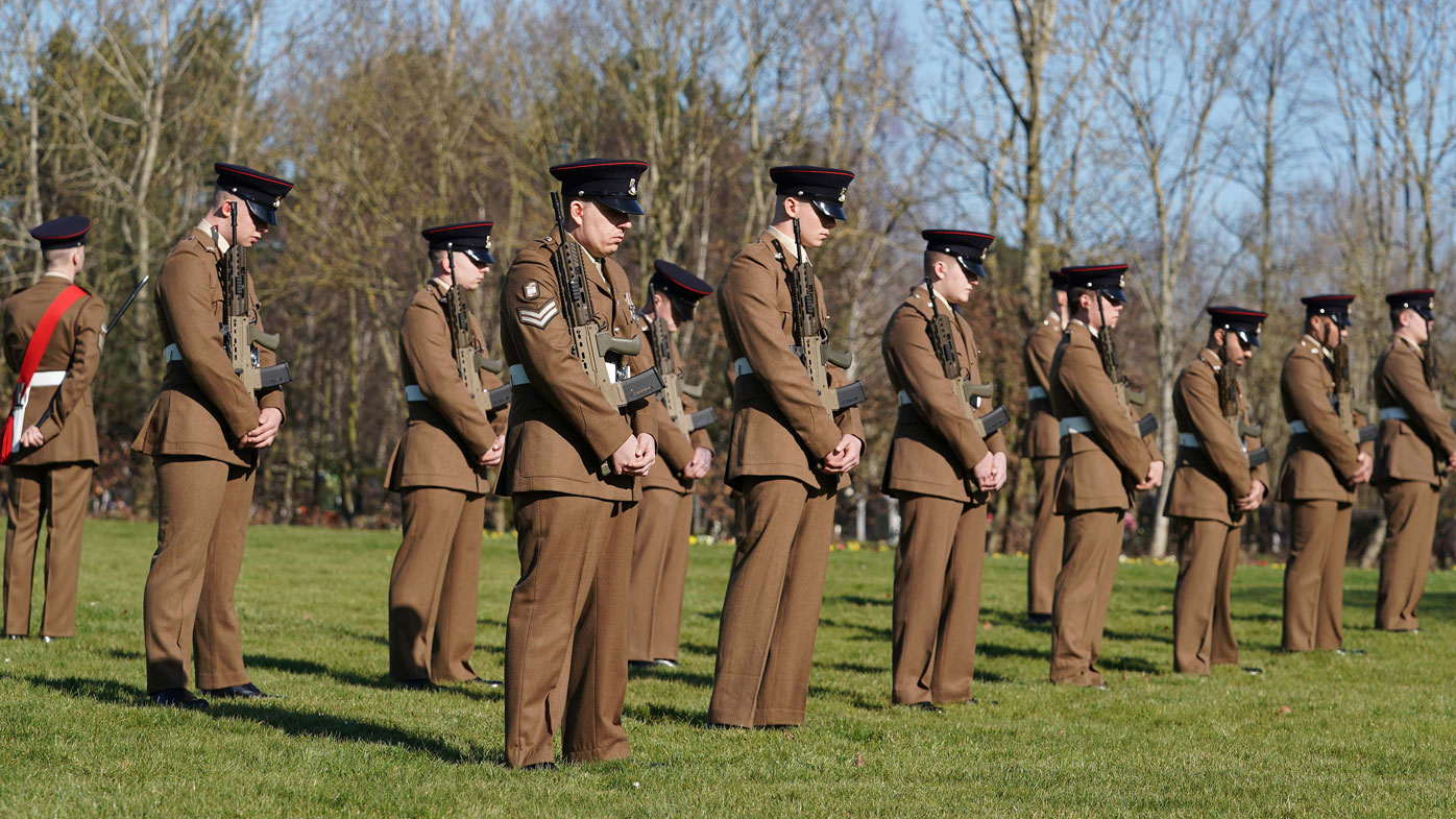  (EDITOR'S NOTE: No reuse after 11.59pm on March 6th 2021 without written consent from gemma@captaintom.org.) Members of the Armed Forces stand in formation during a private funeral service for Captain Sir Tom Moore at Bedford Crematorium on February 27, 2021 in Bedford, England. 