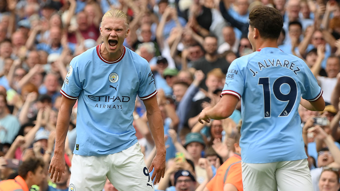 Erling Haaland celebrates a goal with Julian Alvarez