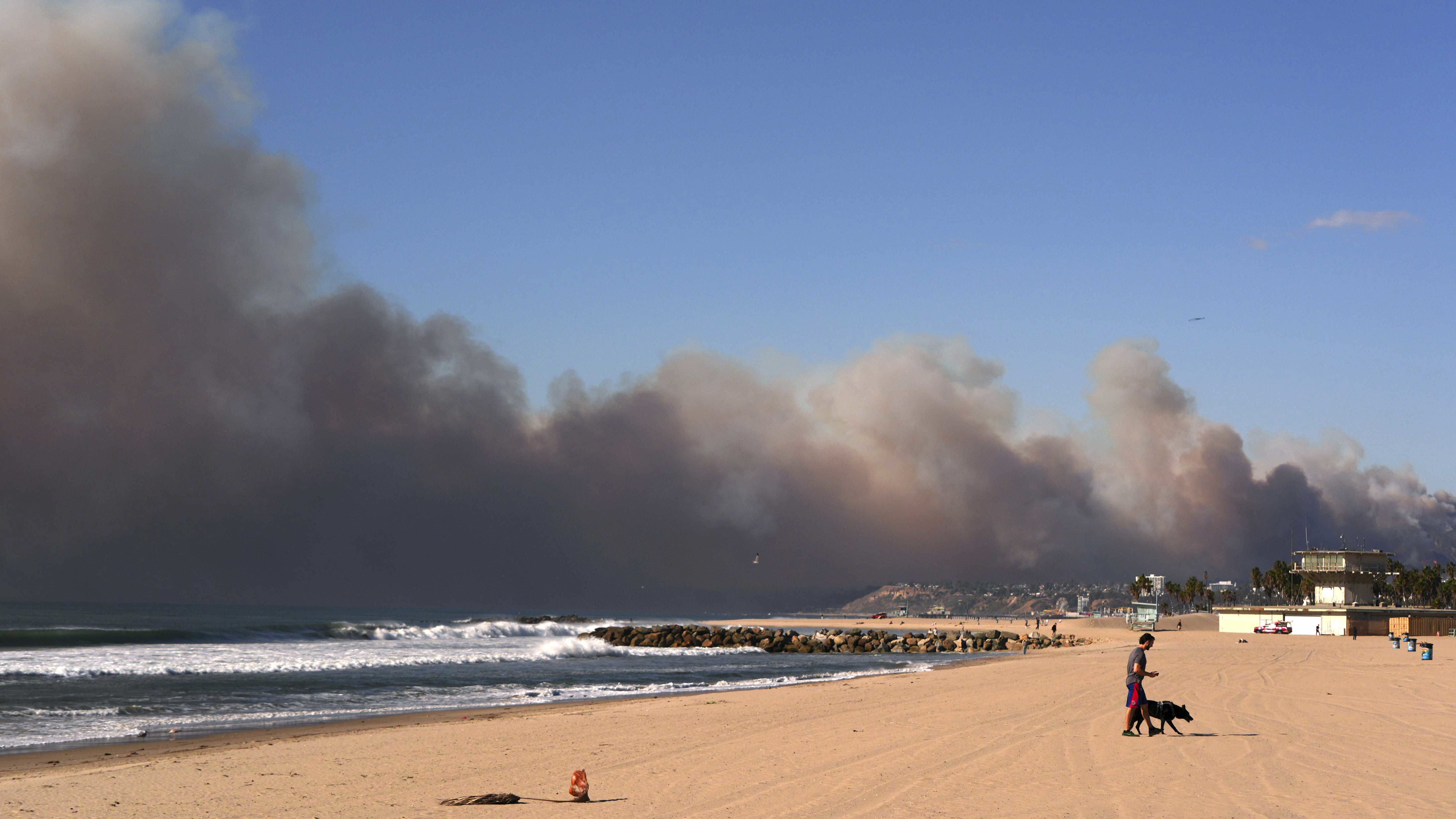 Smoke from a wildfire is seen from the Venice Beach section of Los Angeles.