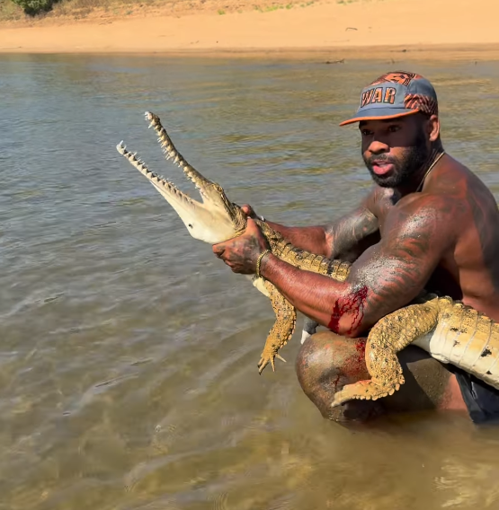A popular American influencer is facing a fine after posting a video of himself grabbing a crocodile in ﻿Far North Queensland. 