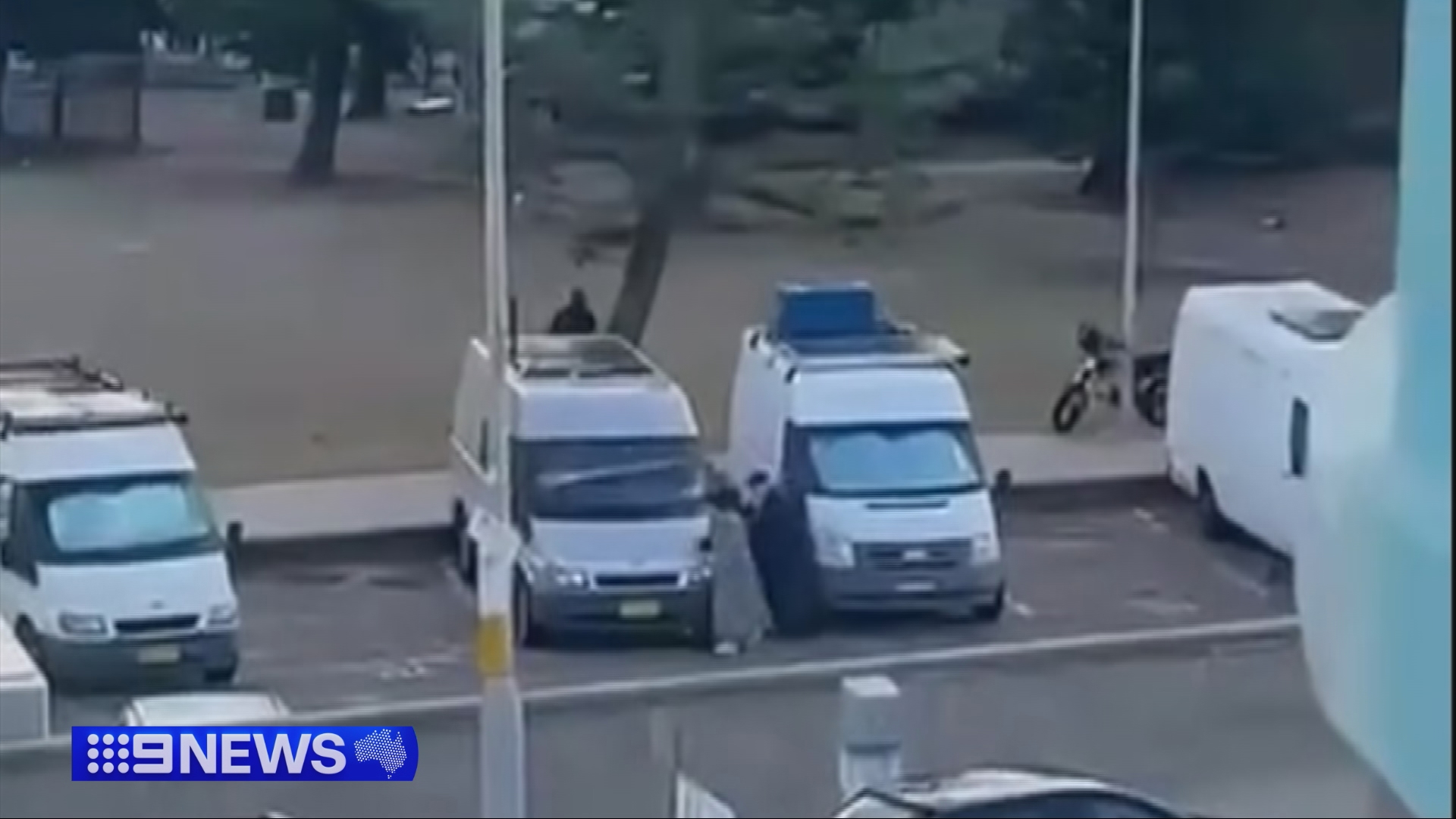 An elderly couple ducks behind vans to hide just metres away from one of the alleged gunmen of the Bondi Beach terrorist attack.