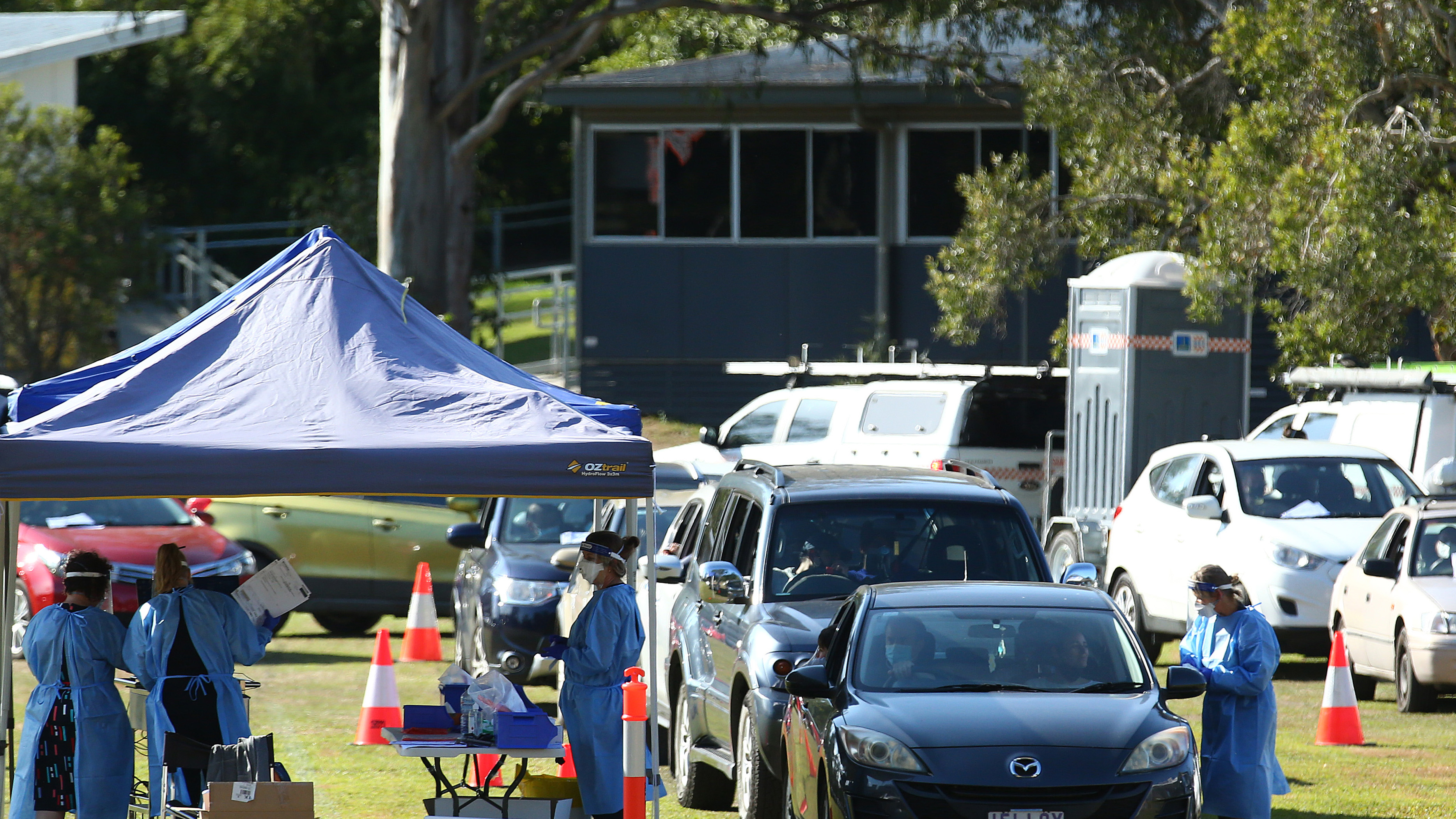 Residents are tested for COVID-19 at a pop up testing clinic at Indooroopilly State High School, in Brisbane.