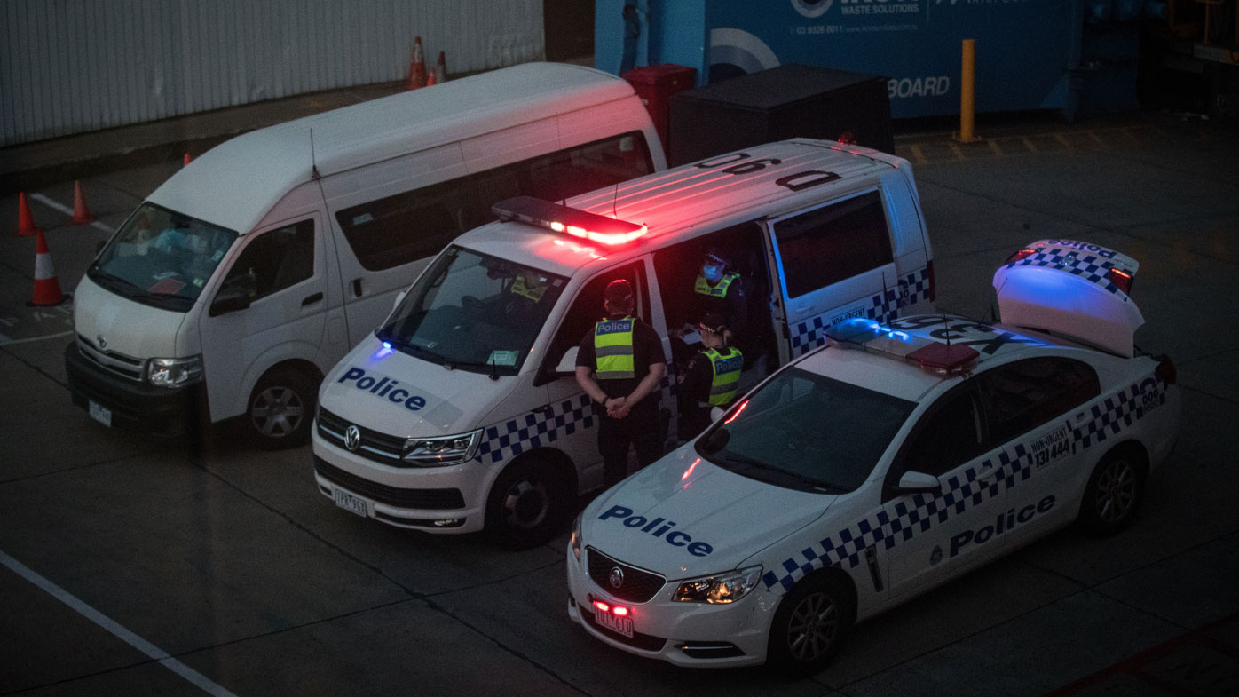 Members of Victoria Police are seen waiting at the International Terminal on January 27, 2021 in Melbourne, Australia.