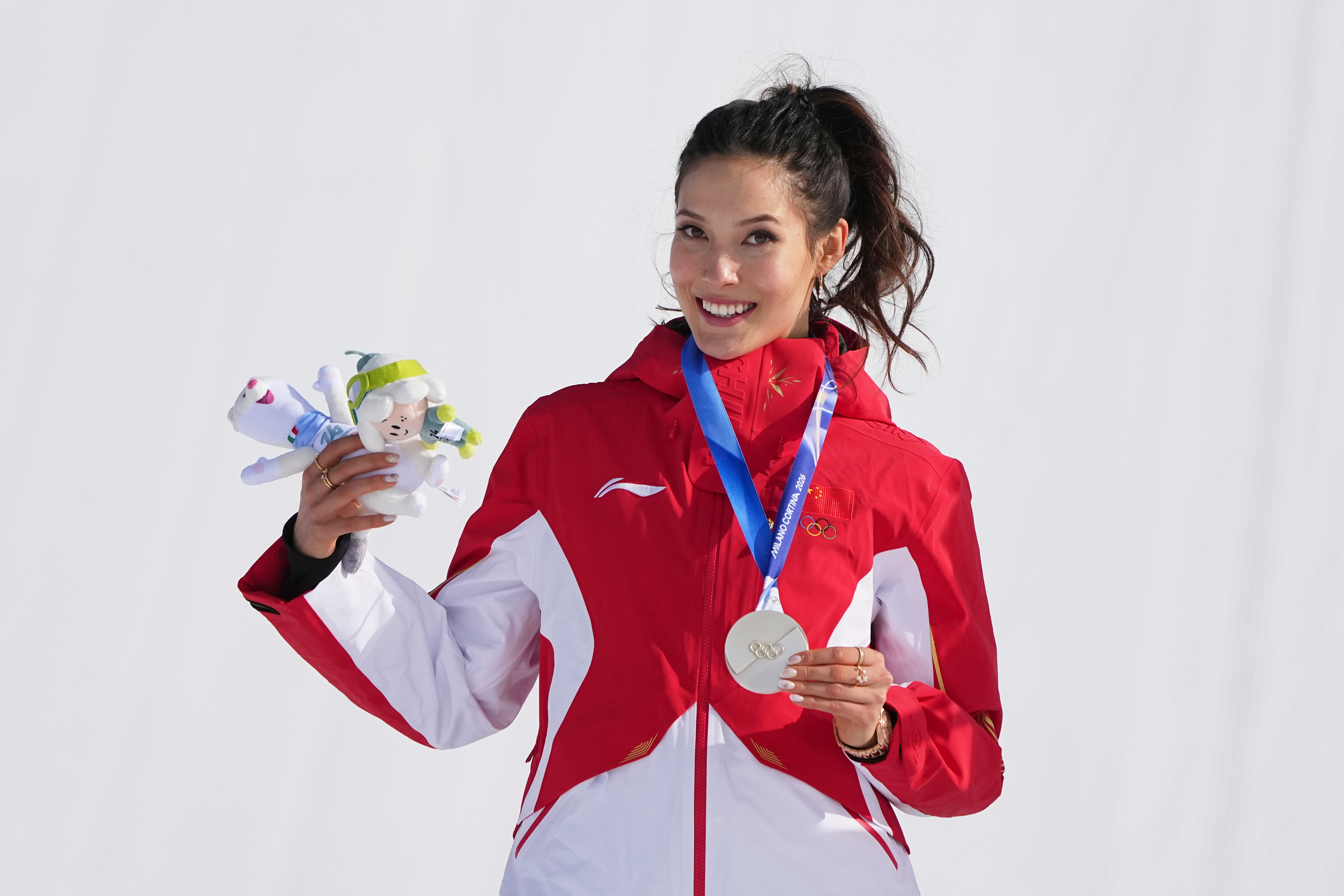 Eileen Gu celebrates with her silver medal after the women's freestyle skiing slopestyle final in Livigno.