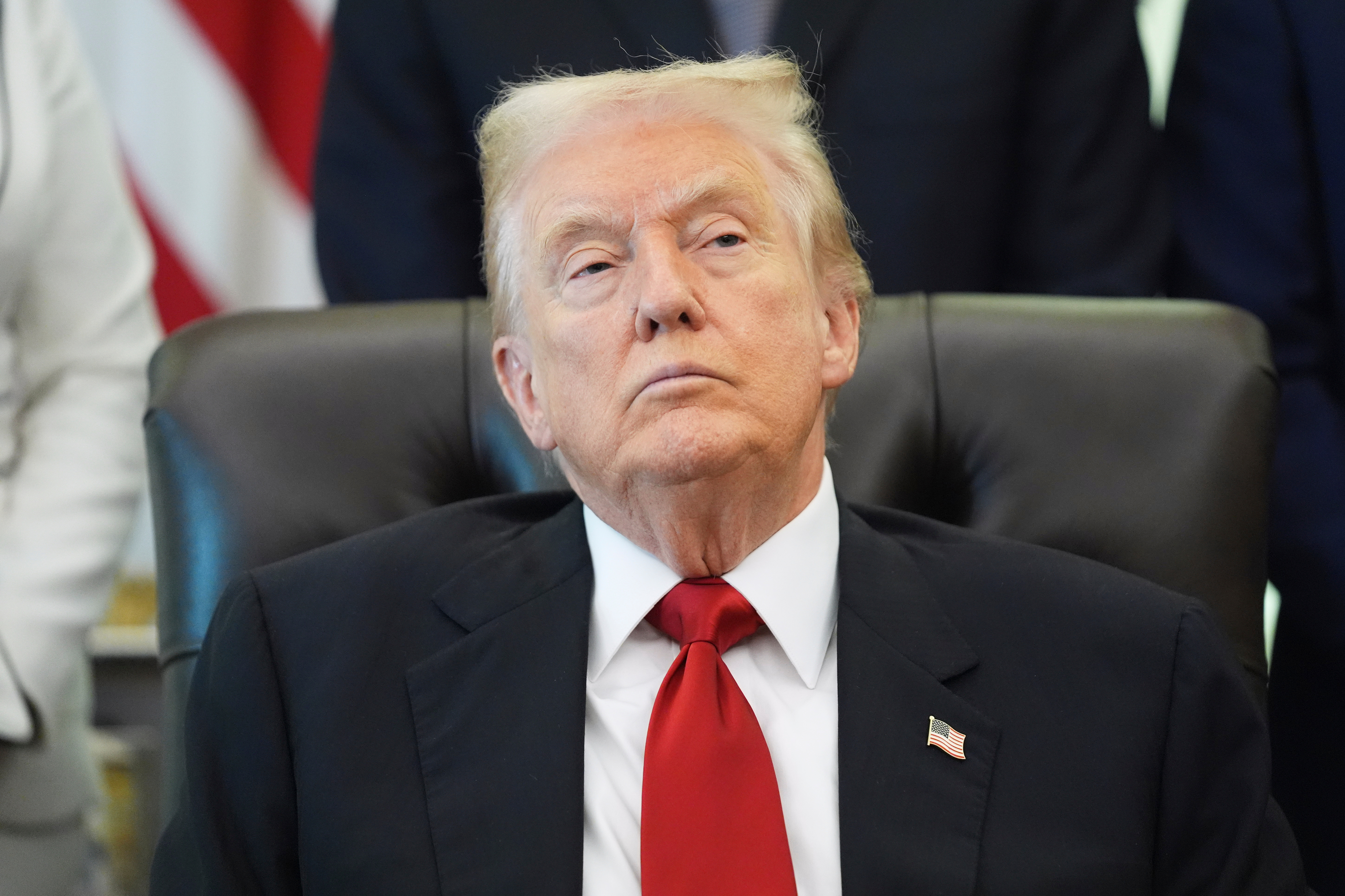 President Donald Trump listens as Health and Human Services Secretary Robert F. Kennedy Jr. speaks during an event about drug prices.