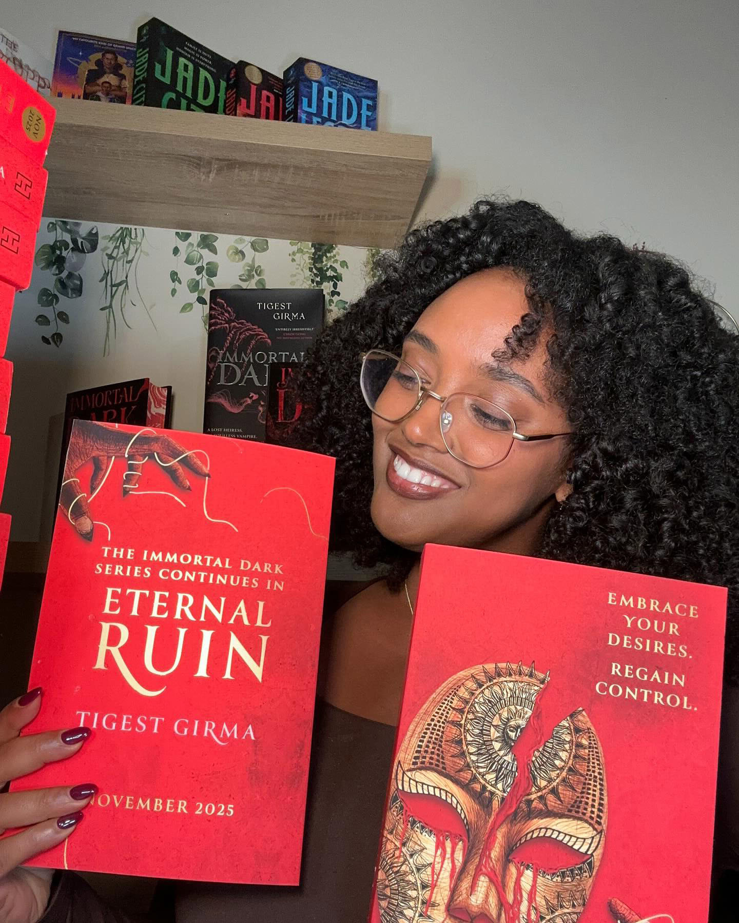 Tigest Girma shows off copies of her second novel, Eternal Ruin.
