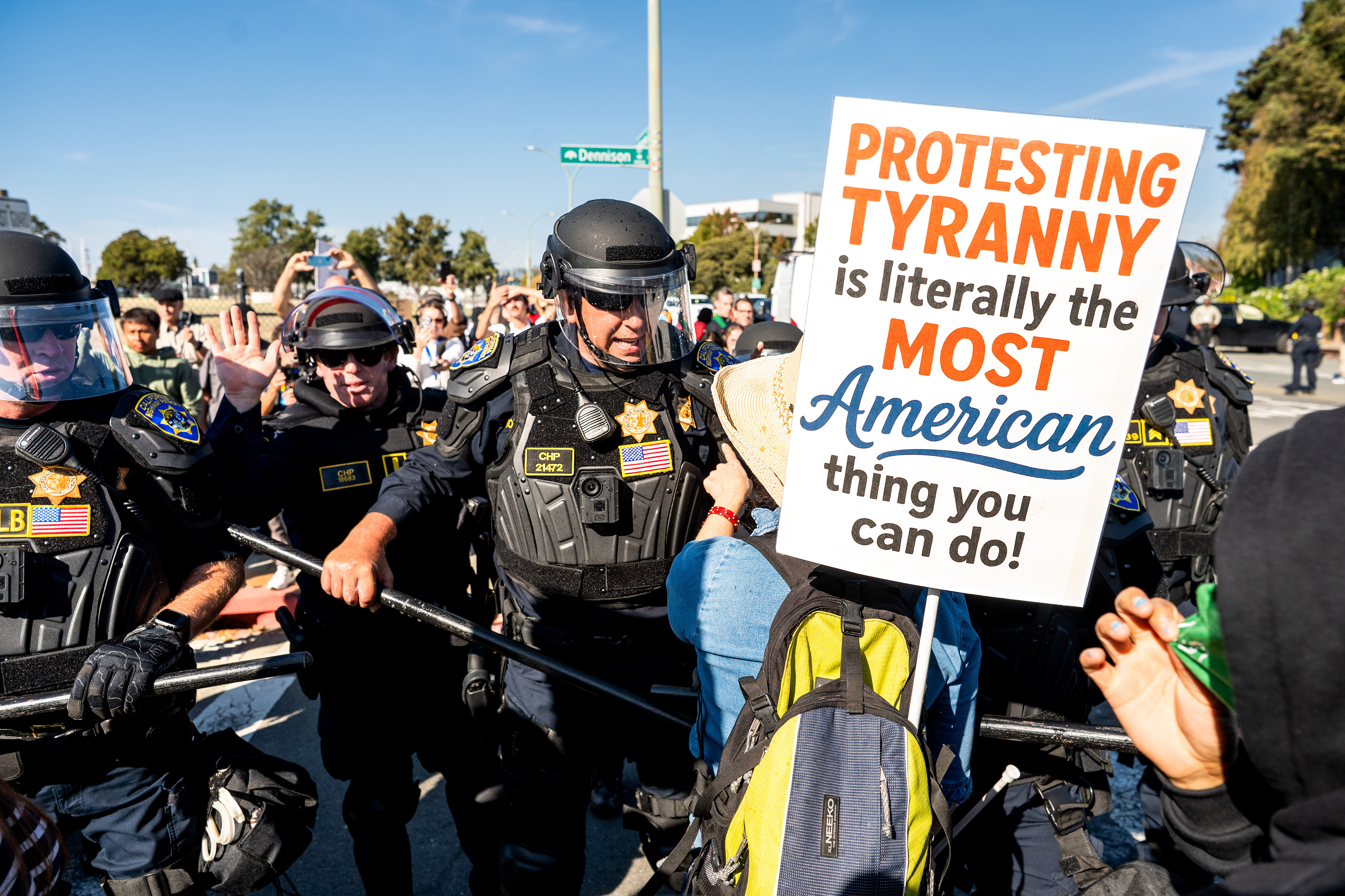 California Highway Patrol officers move back protesters who were blocking the entrance to Coast Guard Base Alameda on Thursday, Oct. 23, 2025, in Oakland, Calif. (AP Photo/Noah Berger)