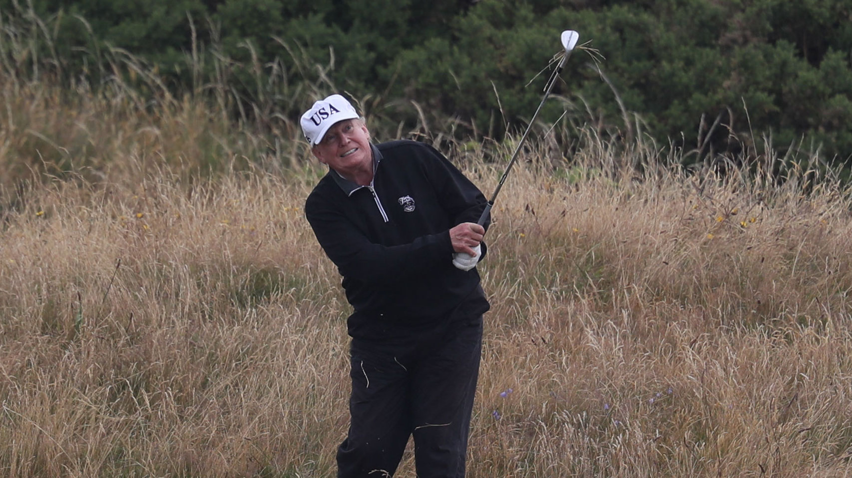 Donald Trump hits a shot during a game of golf.