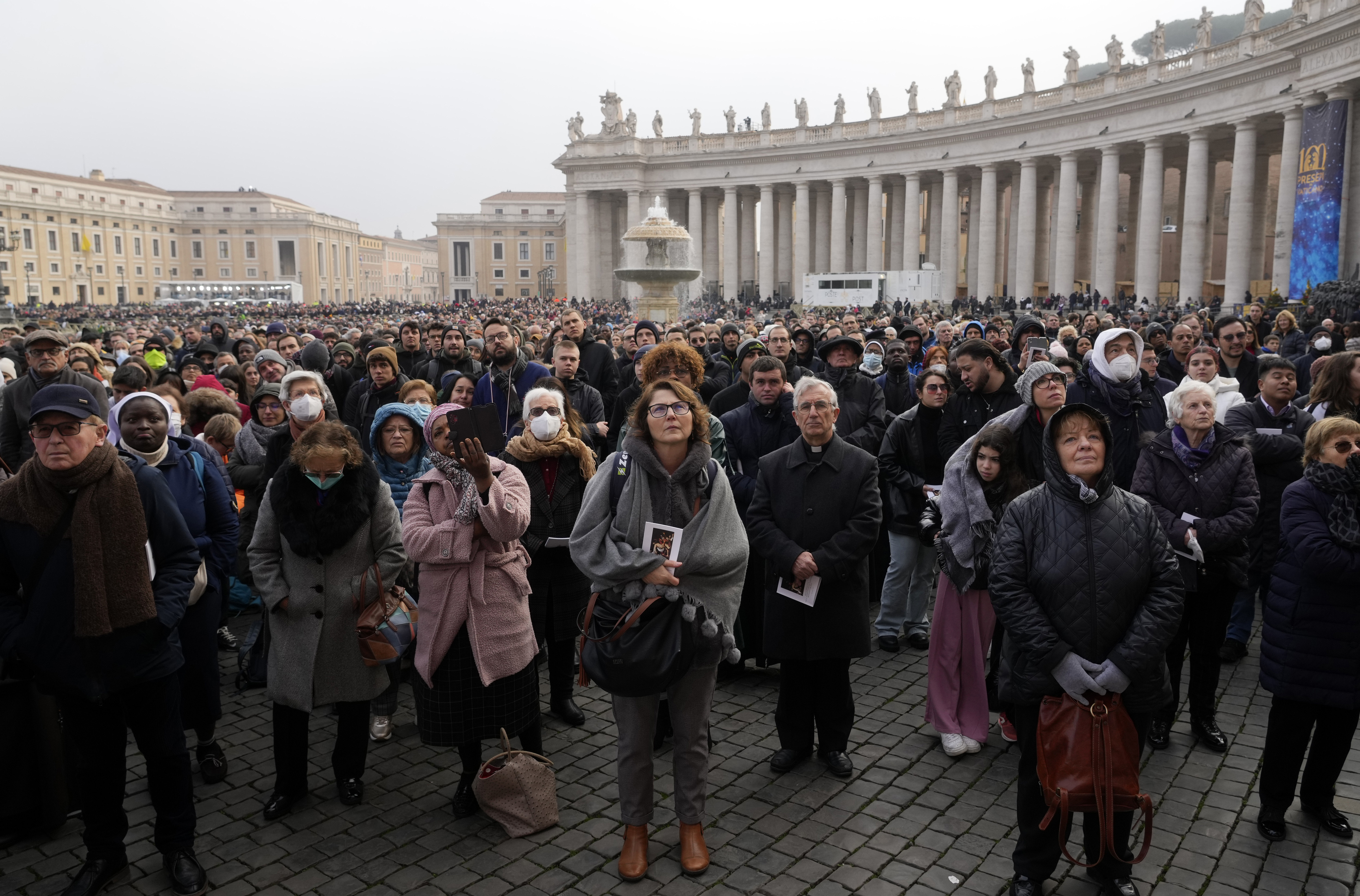 Faithful attend the funeral mass for late Pope Emeritus Benedict XVI in St. Peter's Square at the Vatican, Thursday, Jan. 5, 2023. 