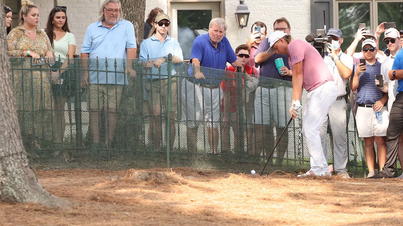 Cameron Smith hits a shot from under the trees on No. 18
