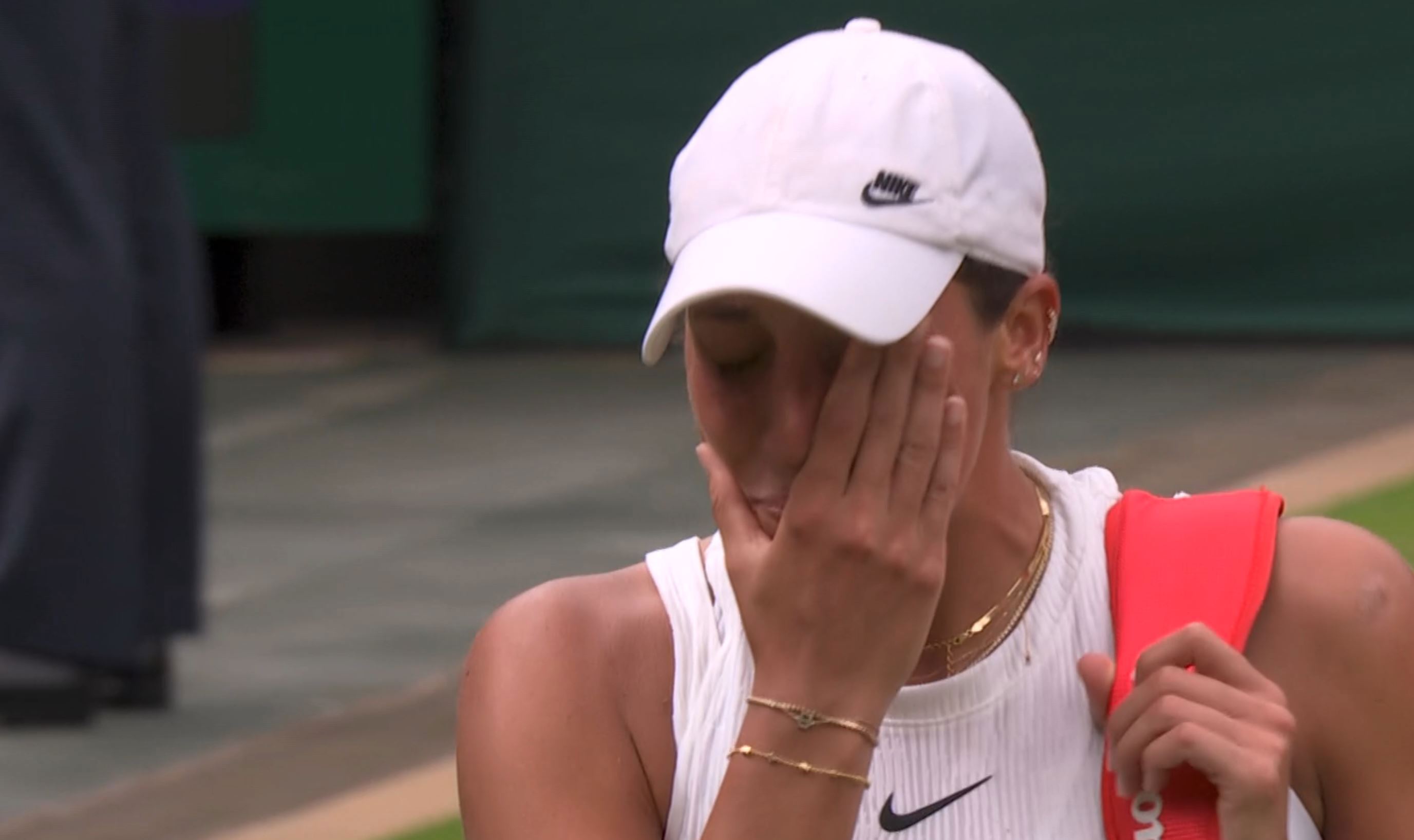 Madison Keys wipes away tears after retiring from her fourth-round match at Wimbledon. 