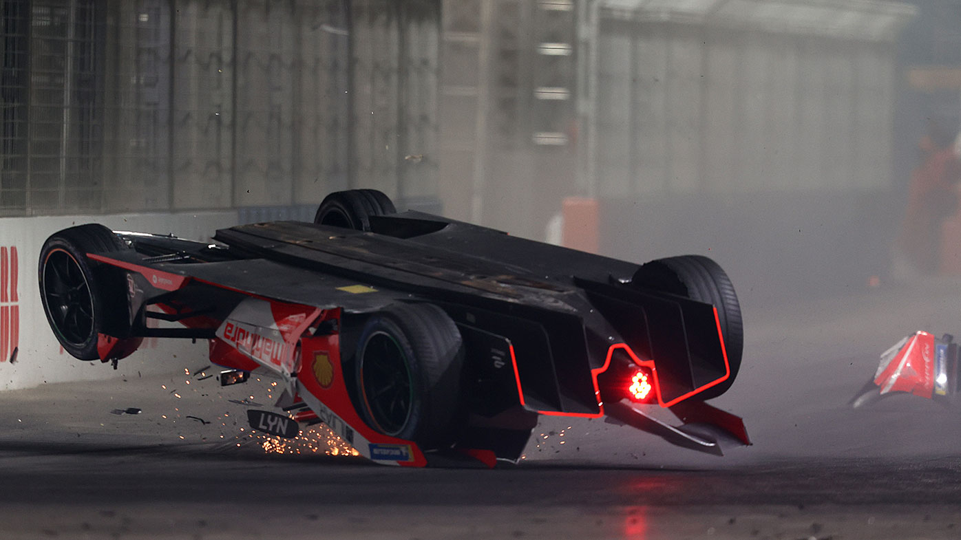 Alex Lynn's car lands upside down after a collision with Mitch Evans in the Formula E race in Saudi Arabia.
