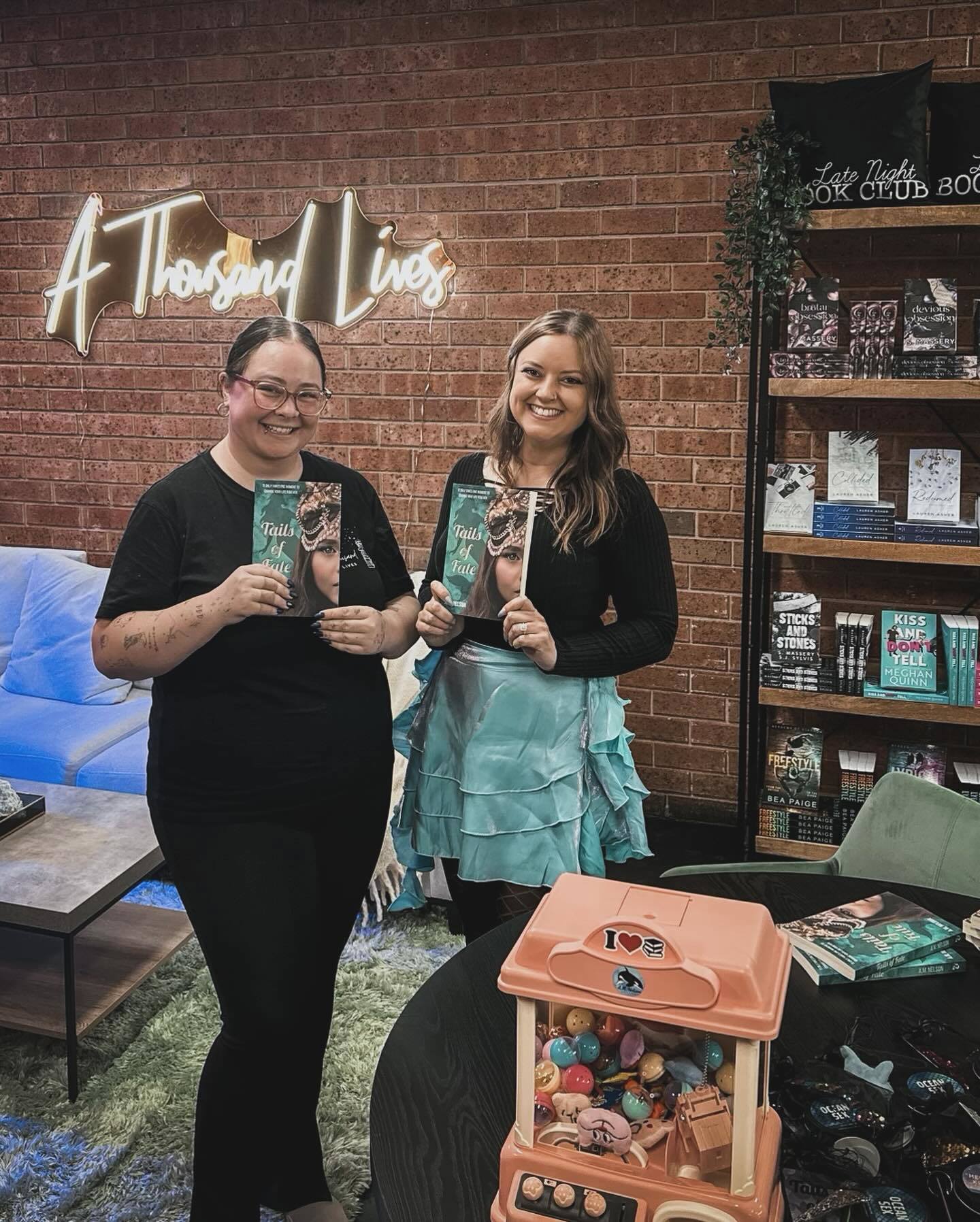 Caitlyn (left) with an author at one of A Thousand Lives Book Haven's reader events.