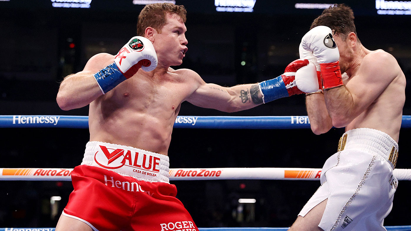 Canelo Alvarez punches Callum Smith during their super middleweight title bout at the Alamodome on December 19, 2020