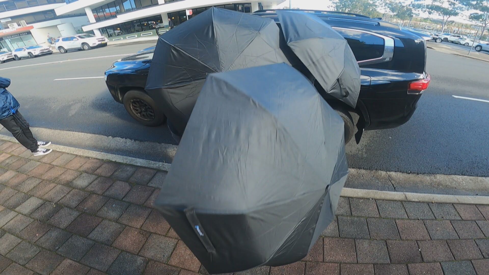 Outside court, the 19-year-old's mother and two brothers wore face masks and shielded themselves with umbrellas, swearing at reporters before getting into a waiting car and driving off.