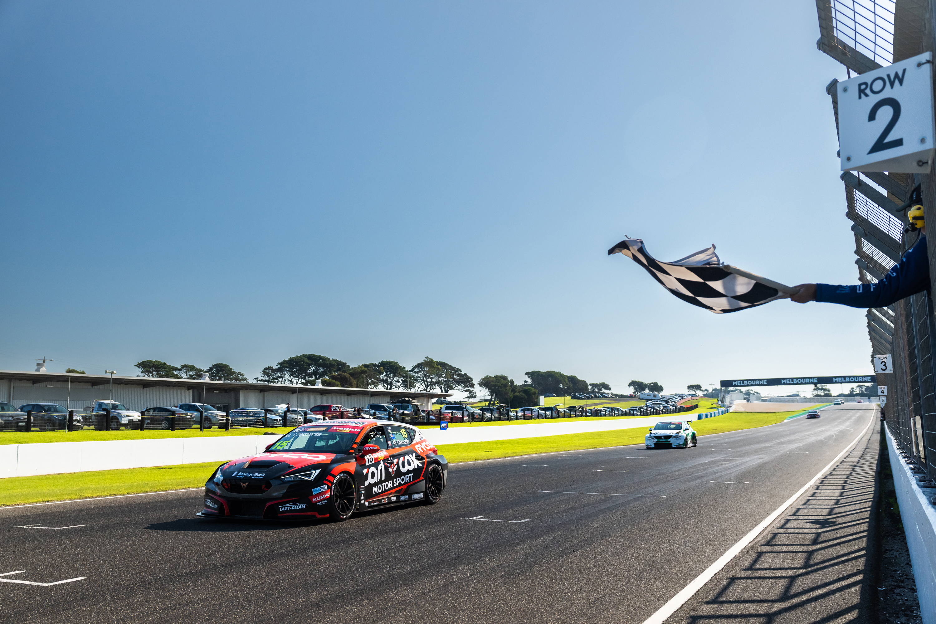 Michael Clemente takes the chequered flag in race two at Phillip Island, his first TCR Australia Series win.