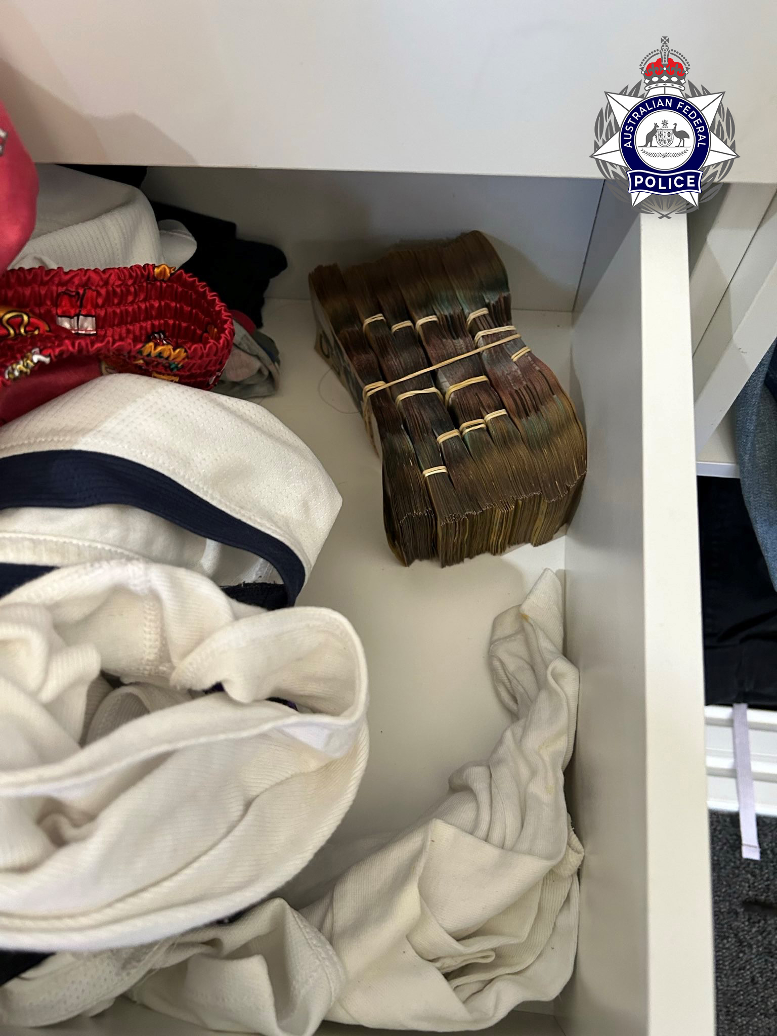 An AFP photo of a drawer containing a wad of cash beside some clothes.