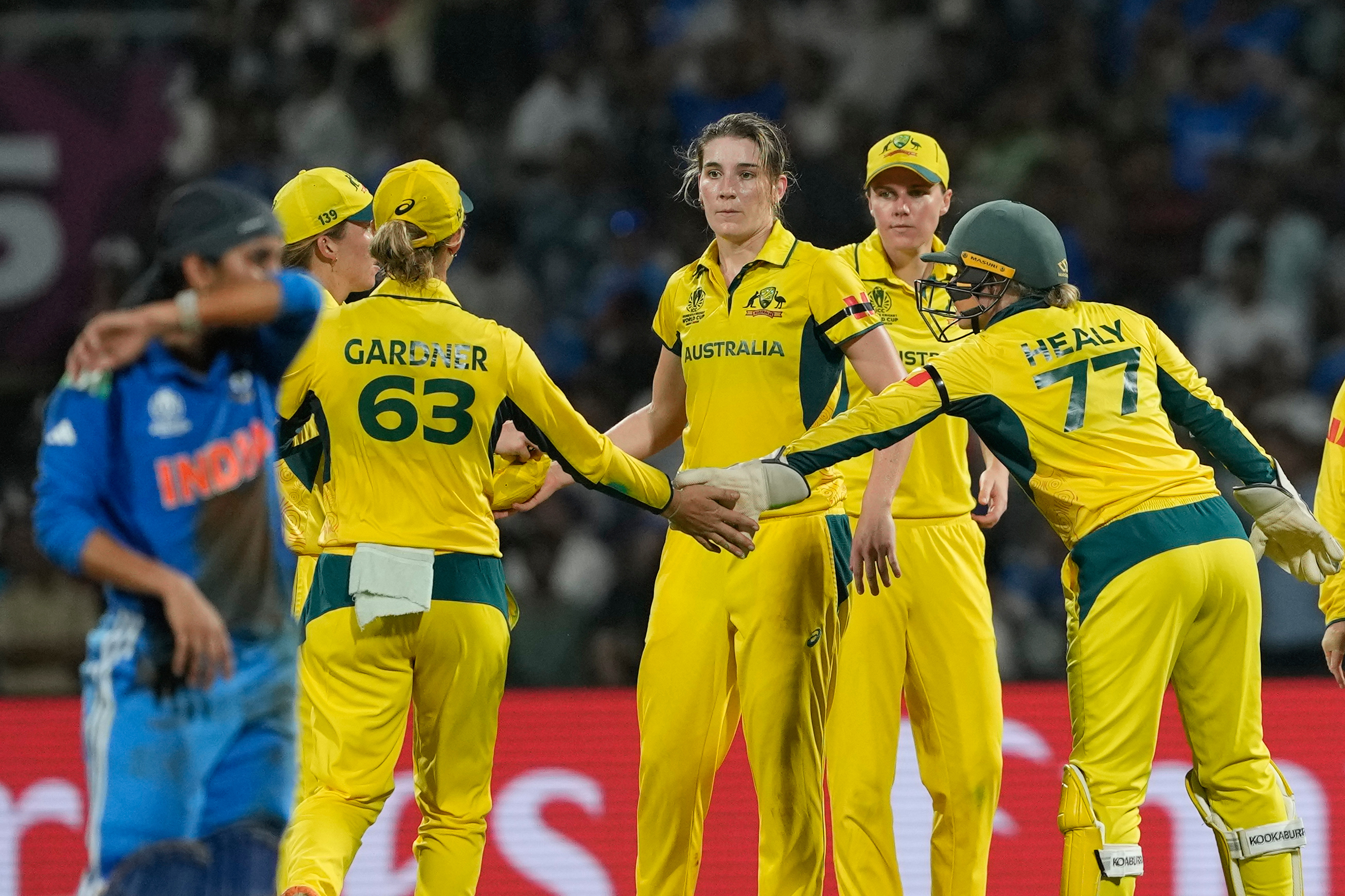 Australia's Annabel Sutherland, centre, celebrates the wicket of India's Richa Ghosh with her teammates during the ICC Women's Cricket World Cup cricket semi final match between India and Australia at DY Patil Stadium in Navi Mumbai, India, Thursday, Oct. 30, 2025.