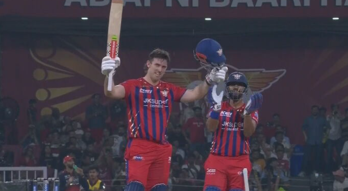Mitch Marsh raises his bat.