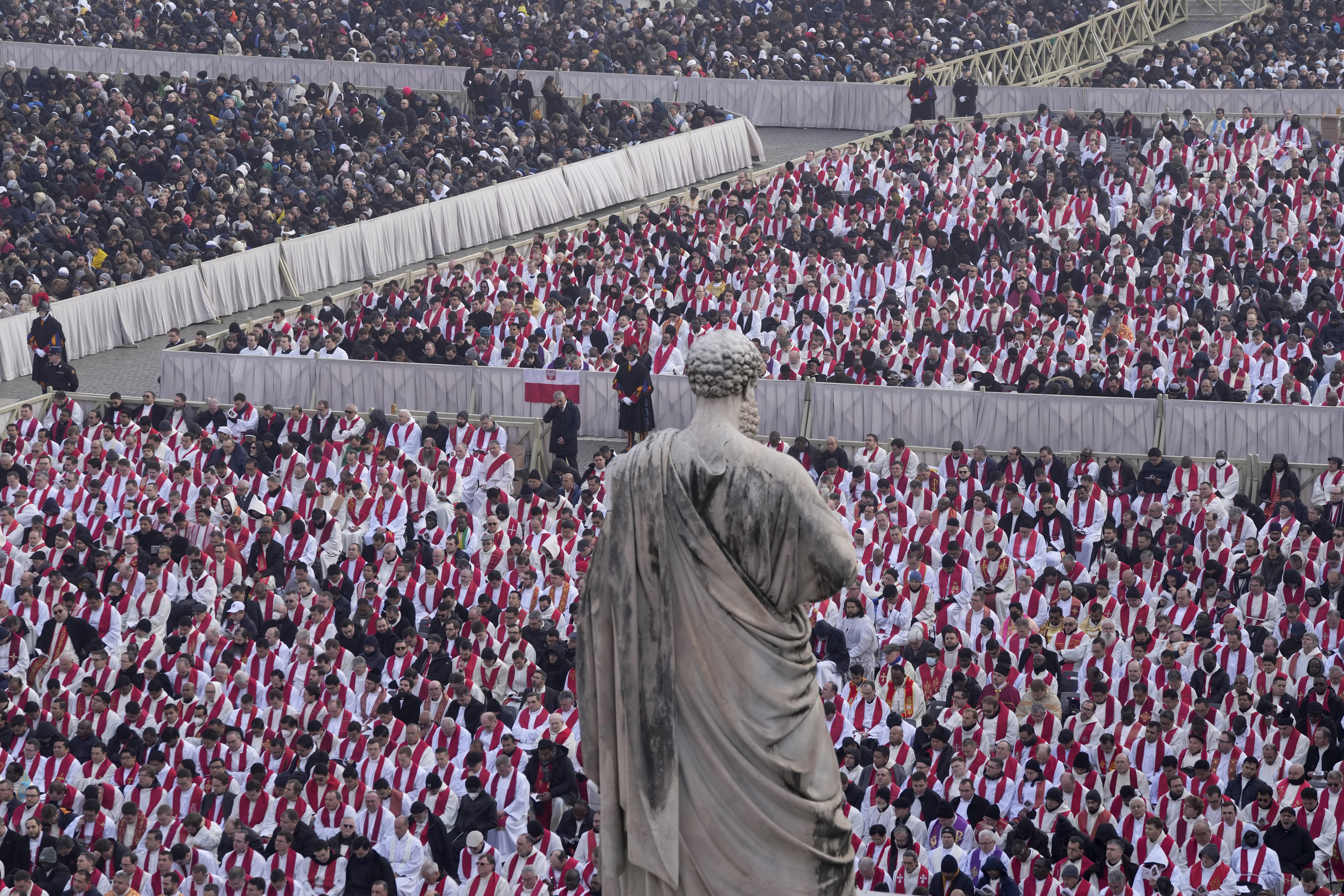 Faithful attend the funeral mass for late Pope Emeritus Benedict XVI in St. Peter's Square at the Vatican, Thursday, Jan. 5, 2023. 