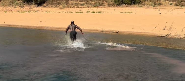 A popular American influencer is facing a fine after posting a video of himself grabbing a crocodile in ﻿Far North Queensland. 