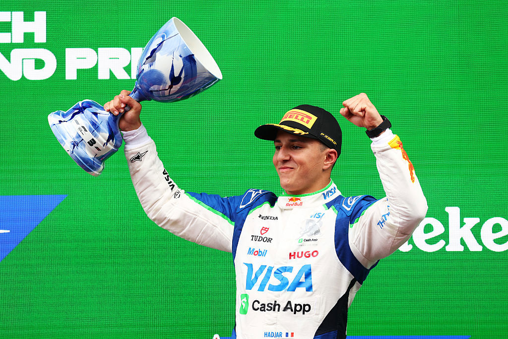 Third placed Isack Hadjar celebrates on the podium with his trophy during the F1 Grand Prix of Netherlands.