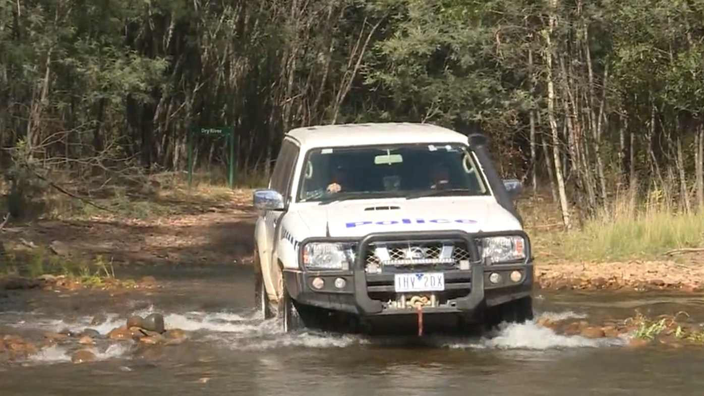 A police car searching the rugged terrain