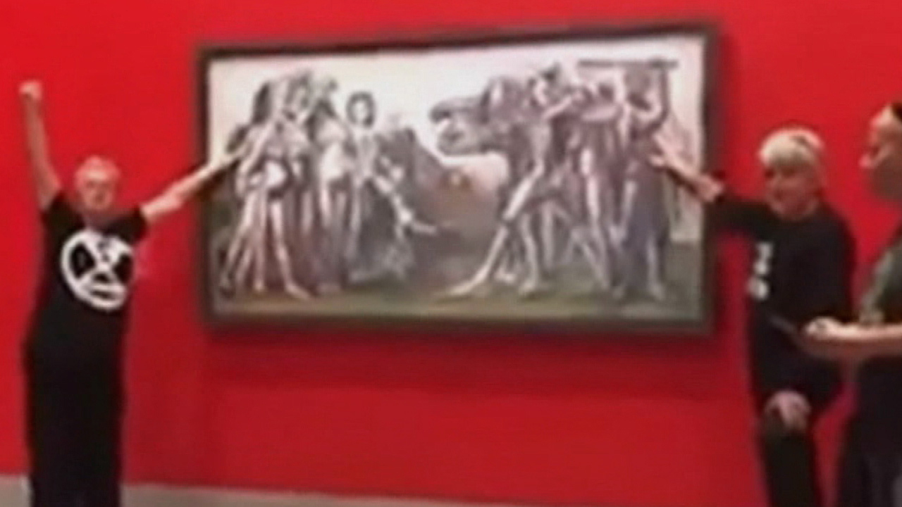 Climate change protesters have been arrested after gluing themselves to a Picasso painting at the National Gallery of Victoria in Melbourne.