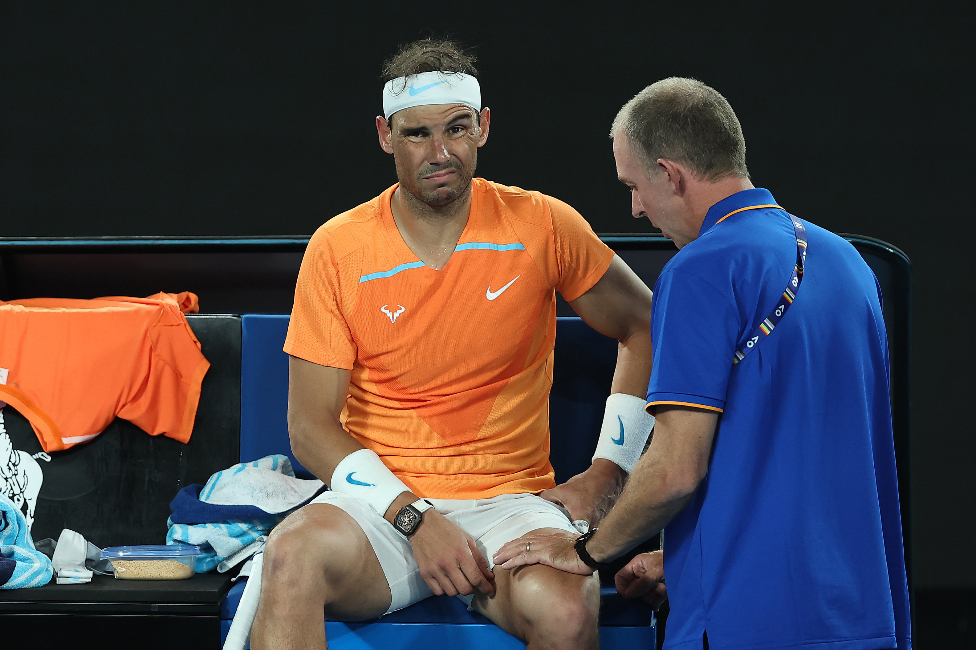 Rafael Nadal of Spain receives attention during a medical time out against Mackenzie McDonald of the United States. (Photo by Cameron Spencer/Getty Images)