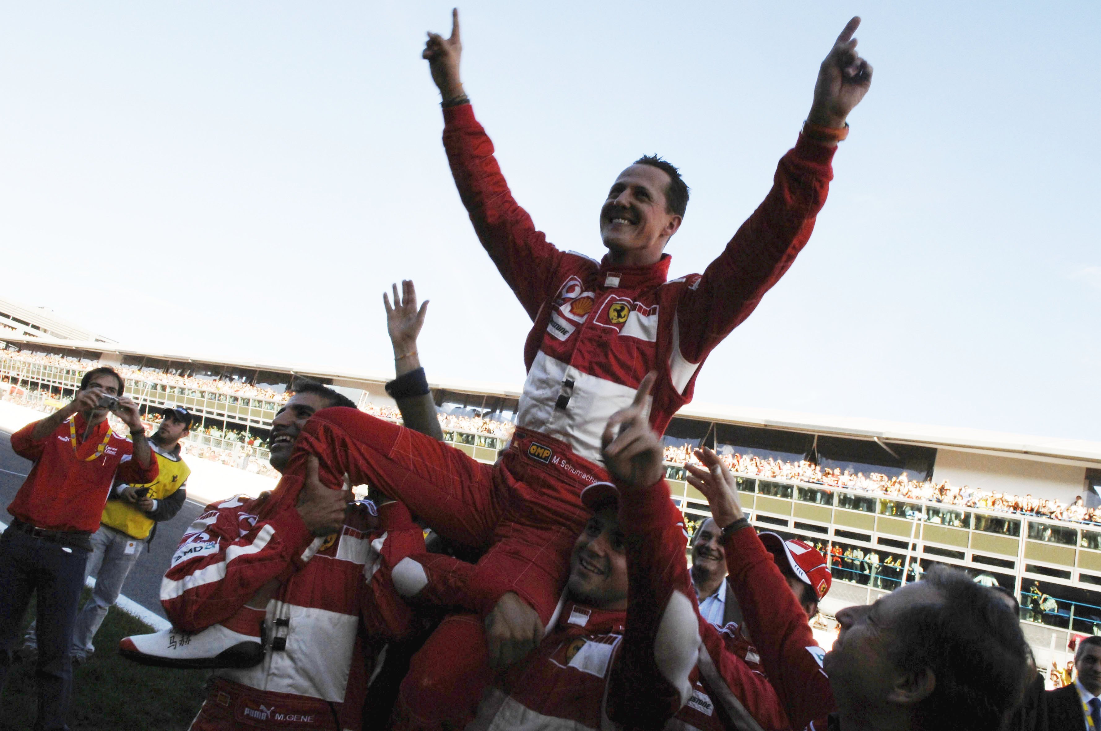 German Ferrari driver Michael Schumacher waves to fans in 2006.