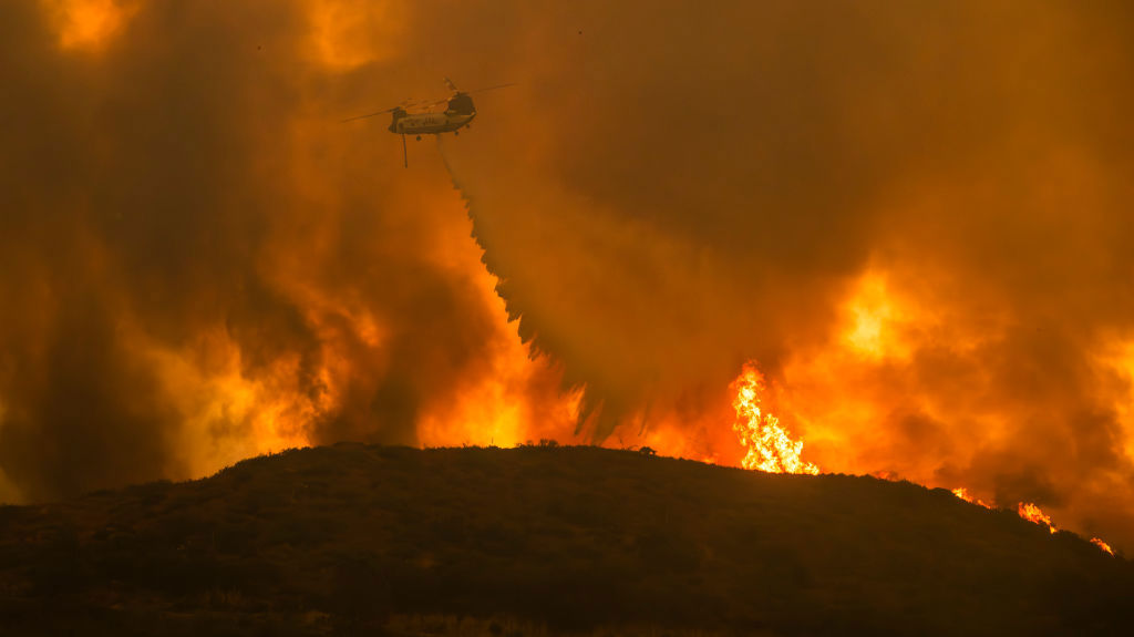 A Cal Fire helicopter makes water drop on the Airport Fire.