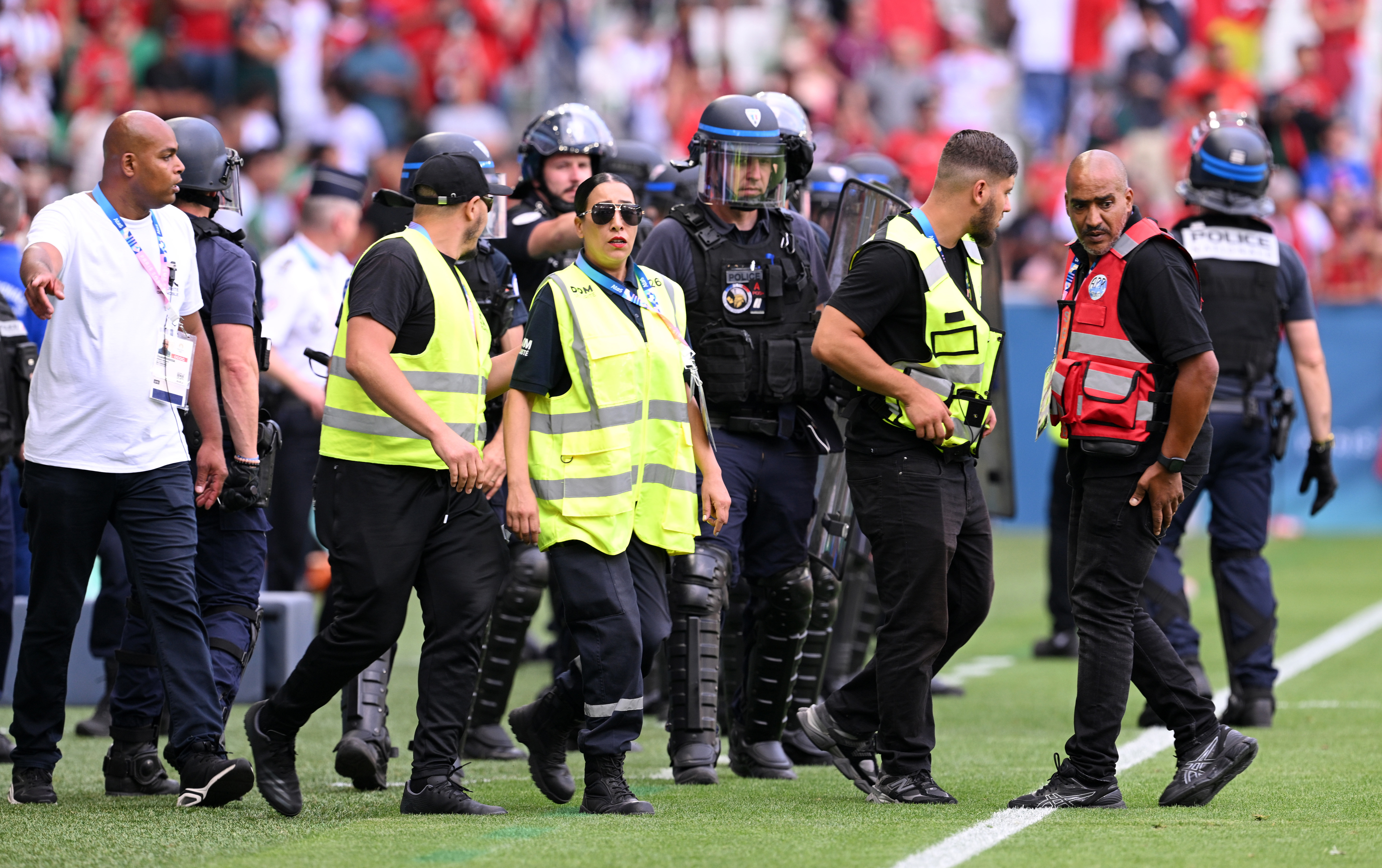 Armed police are seen on the sidelines at Stade Geoffroy-Guichard.