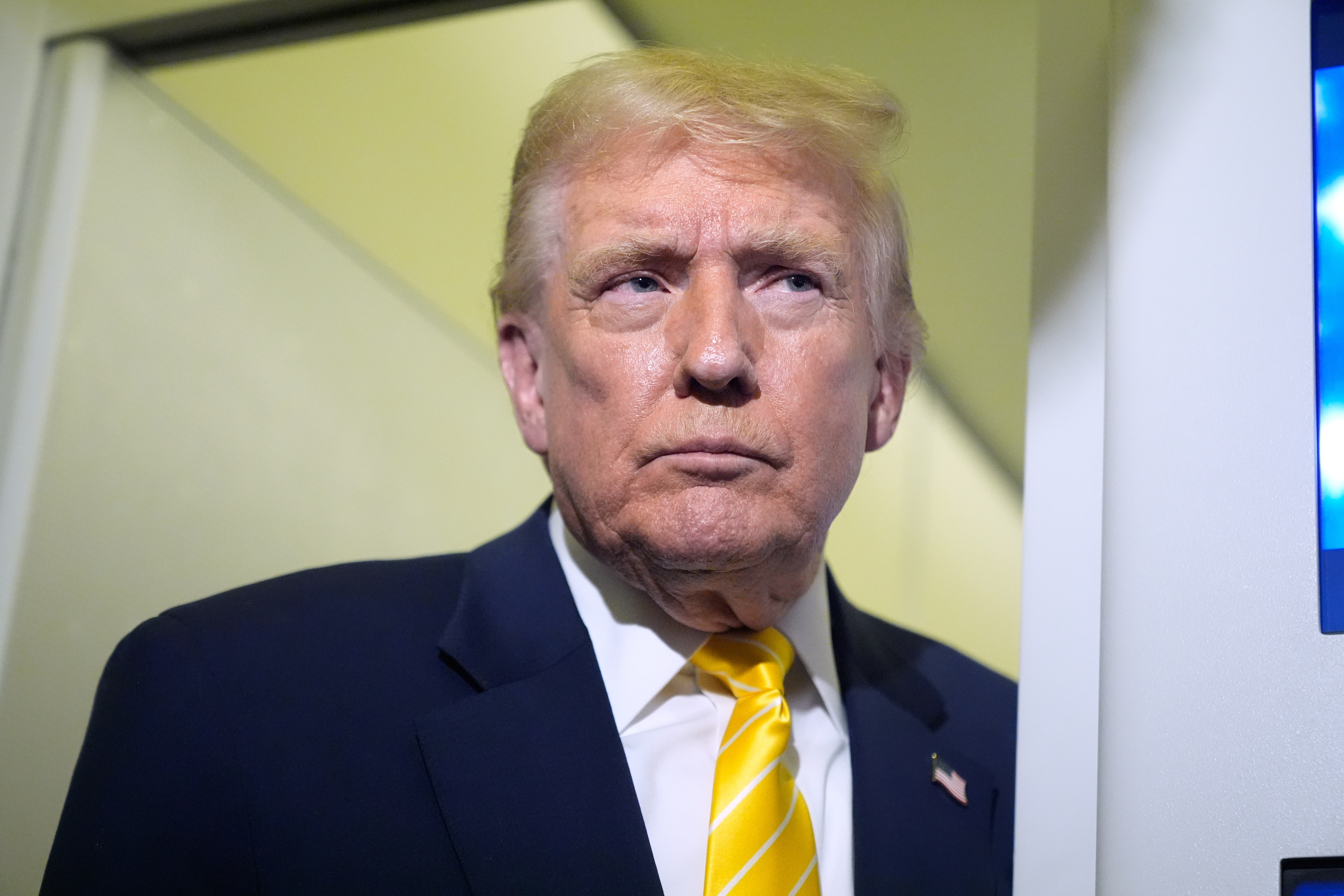 President Donald Trump speaks to reporters on Air Force One on his way to his Mar-a-Lago estate in Palm Beach, Fla., Friday, Nov. 14, 2025. (AP Photo/Manuel Balce Ceneta)