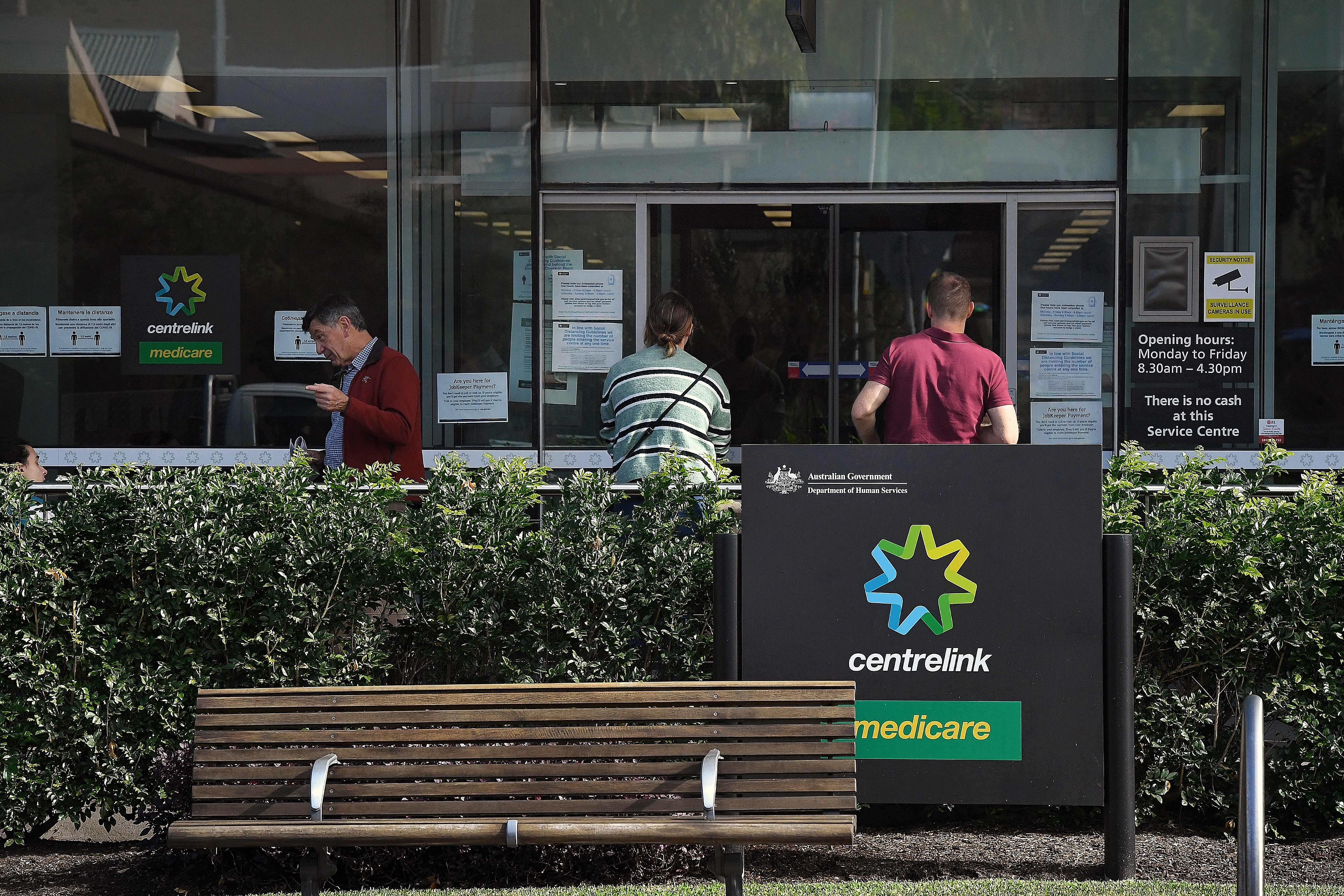 People wait outside a Services Australia outlet