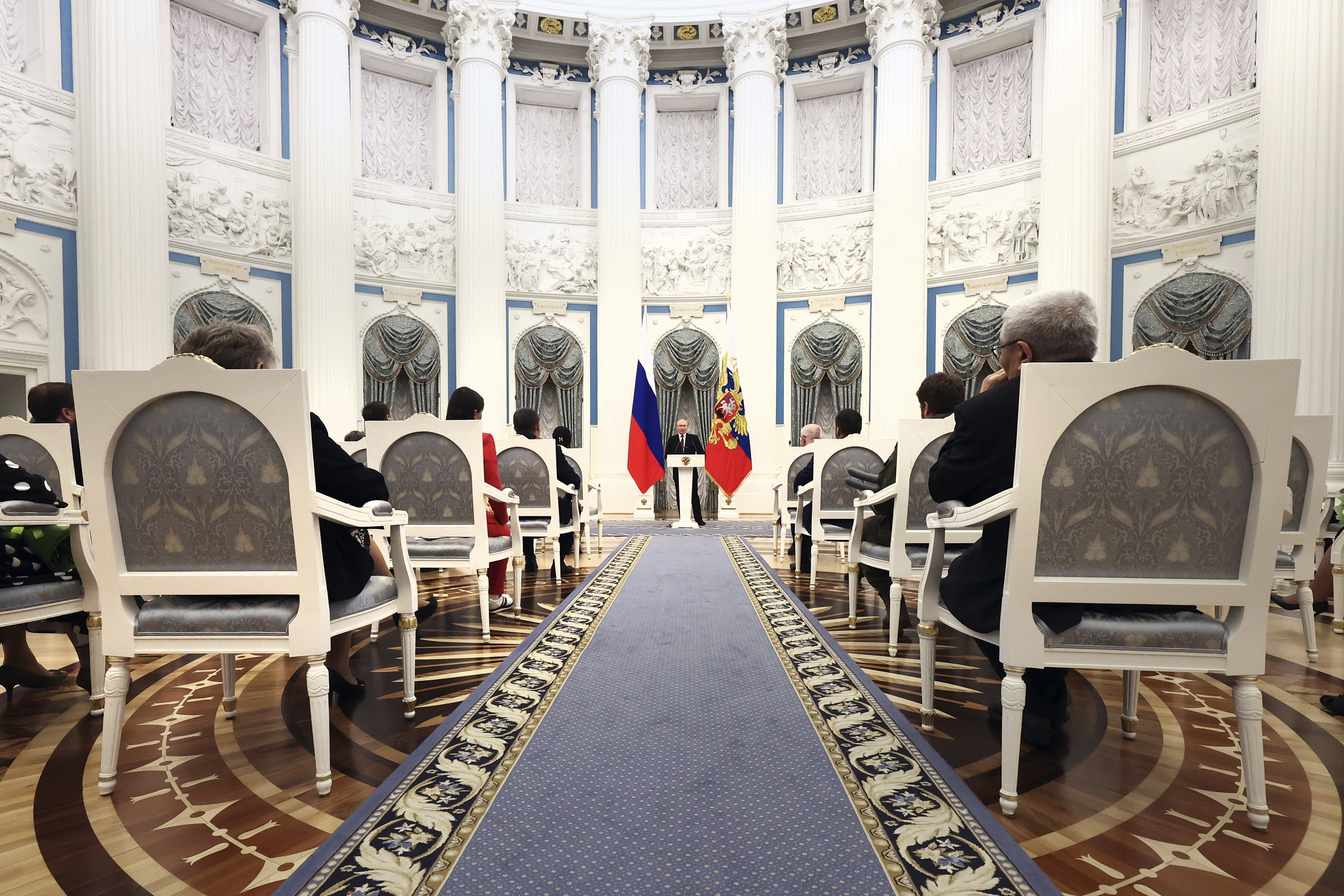 Russian President Vladimir Putin, centre, speaks during an awarding ceremony at the Kremlin's St. Catherine Hall in Moscow, Russia, Tuesday, Dec. 20, 2022.