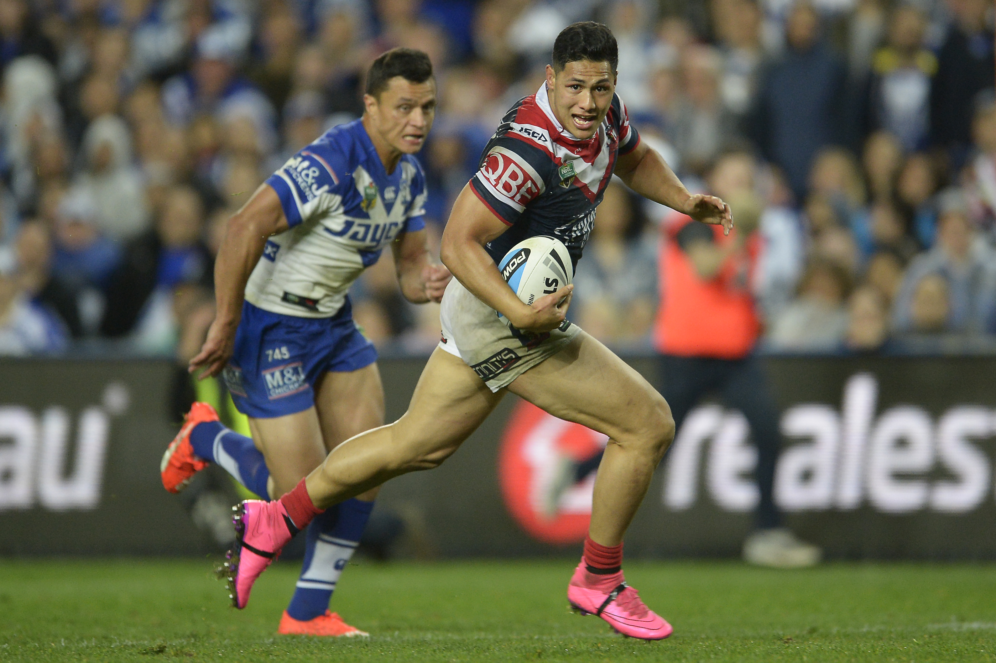 Roger Tuivasa-Sheck of the Roosters makes a break to score a try.