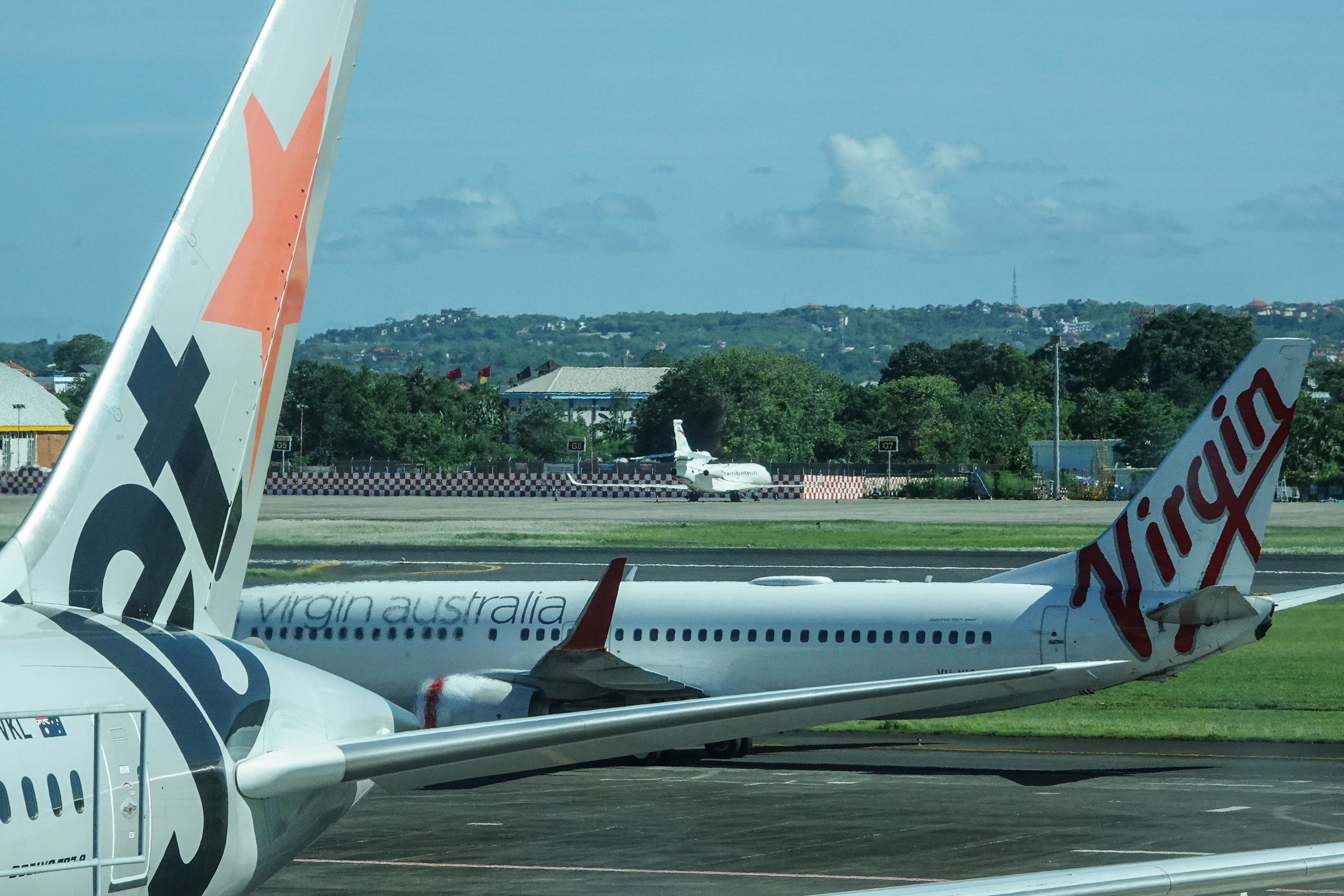 Jetstar and Virgin Australia jets on the tarmac at Gusti Ngurah Rai Airport in Denpasar, Bali. 