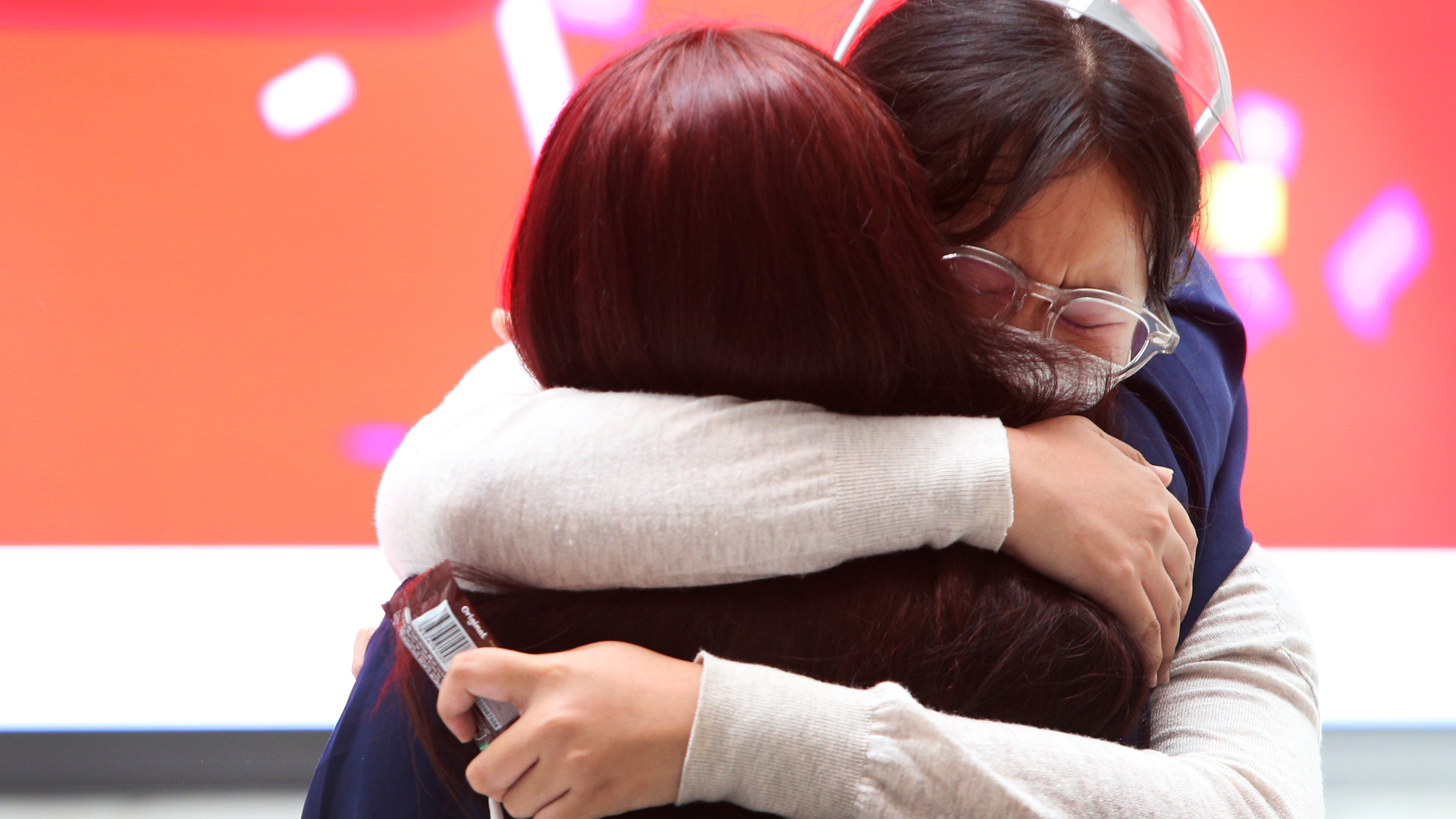 Family members embrace as they are reunited at the Sydney International Airport on November 1.