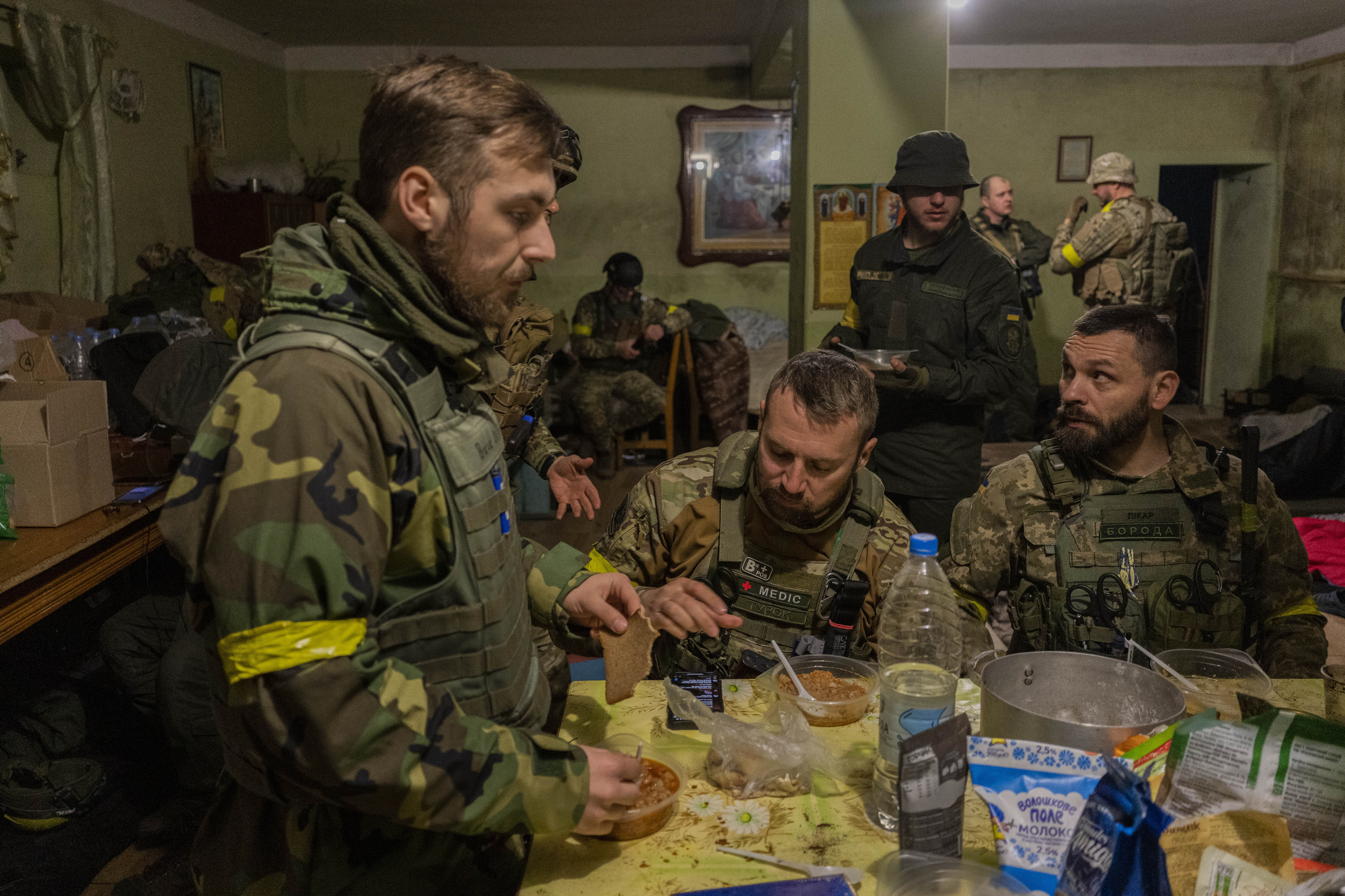 Ukrainian National Guard soldiers gather in a house used as temporary base in a recently retaken village on the outskirts of Kharkiv, east Ukraine, Saturday, May 14, 2022. 