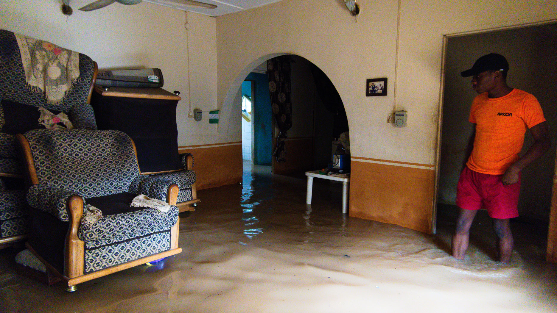 A Nigerian man removes water from his house after heavy rains caused flood in Lagos, Nigeria on June 18, 2020.