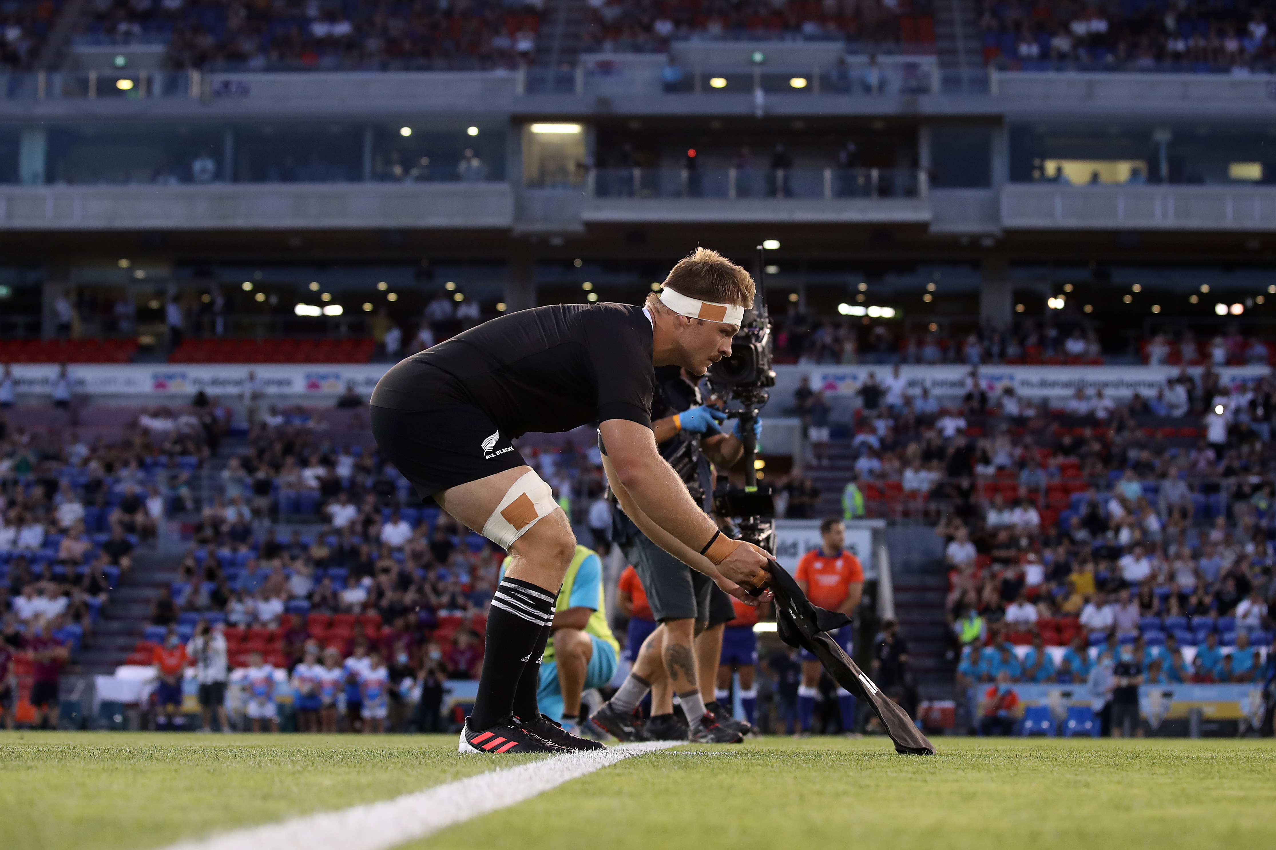 Sam Cane of the All Blacks lays down a number 10 jersey in memory of Diego Maradona.