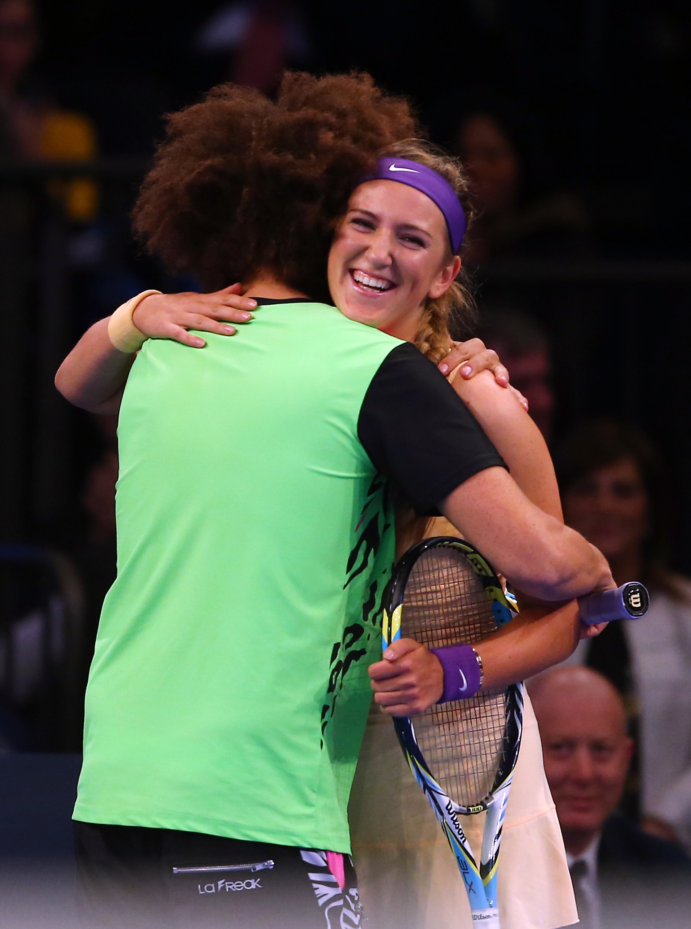 LMFAO singer Redfoo hugs Victoria Azarenka of Belarus during her match against Serena Williams of the USA the BNP Paribas Showdown on March 4, 2013 at Madison Square Garden in New York City. (Photo by Elsa/Getty Images)