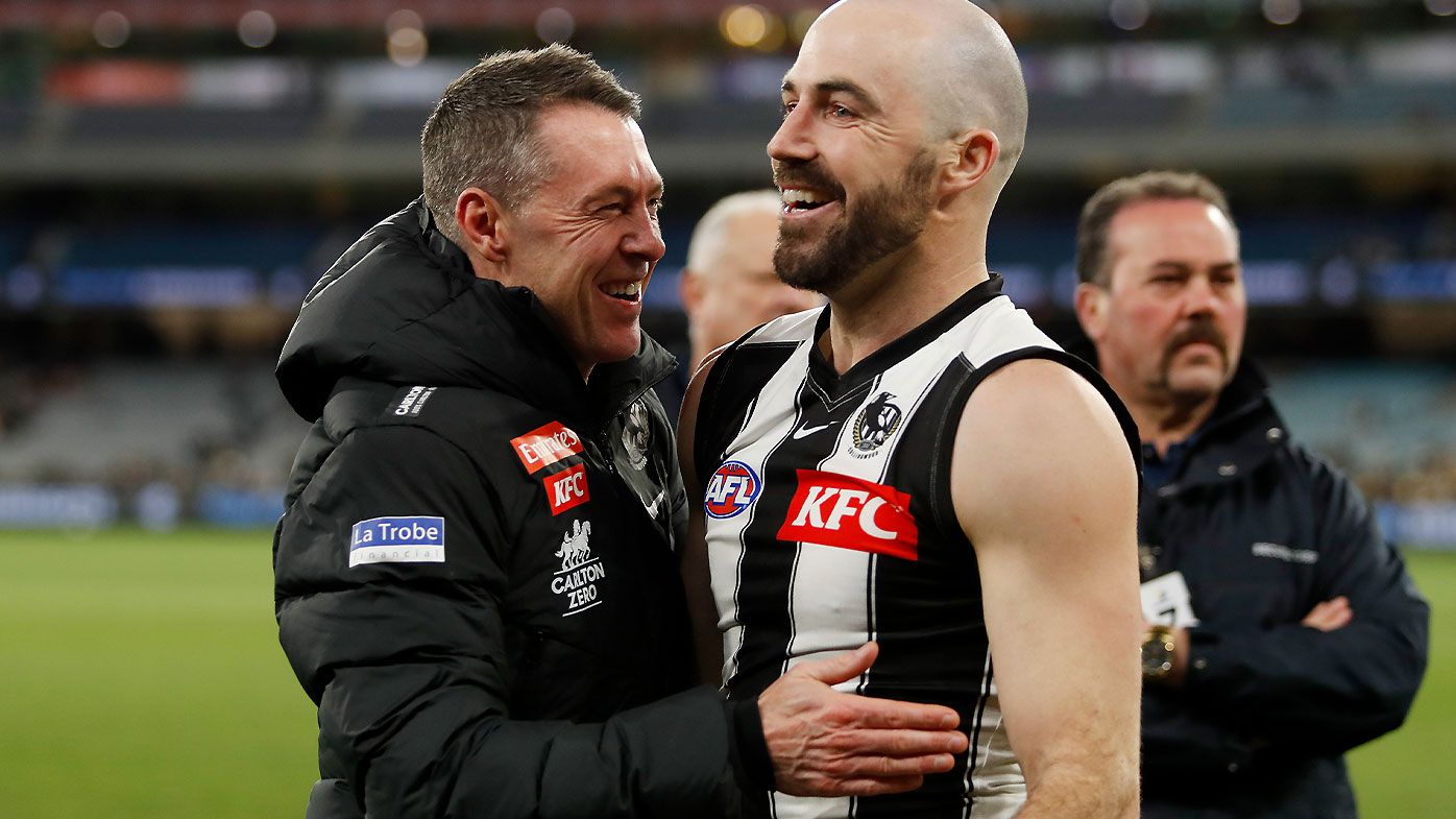 Collingwood coach Craig McRae celebrates the win over Carlton with Steele Sidebottom