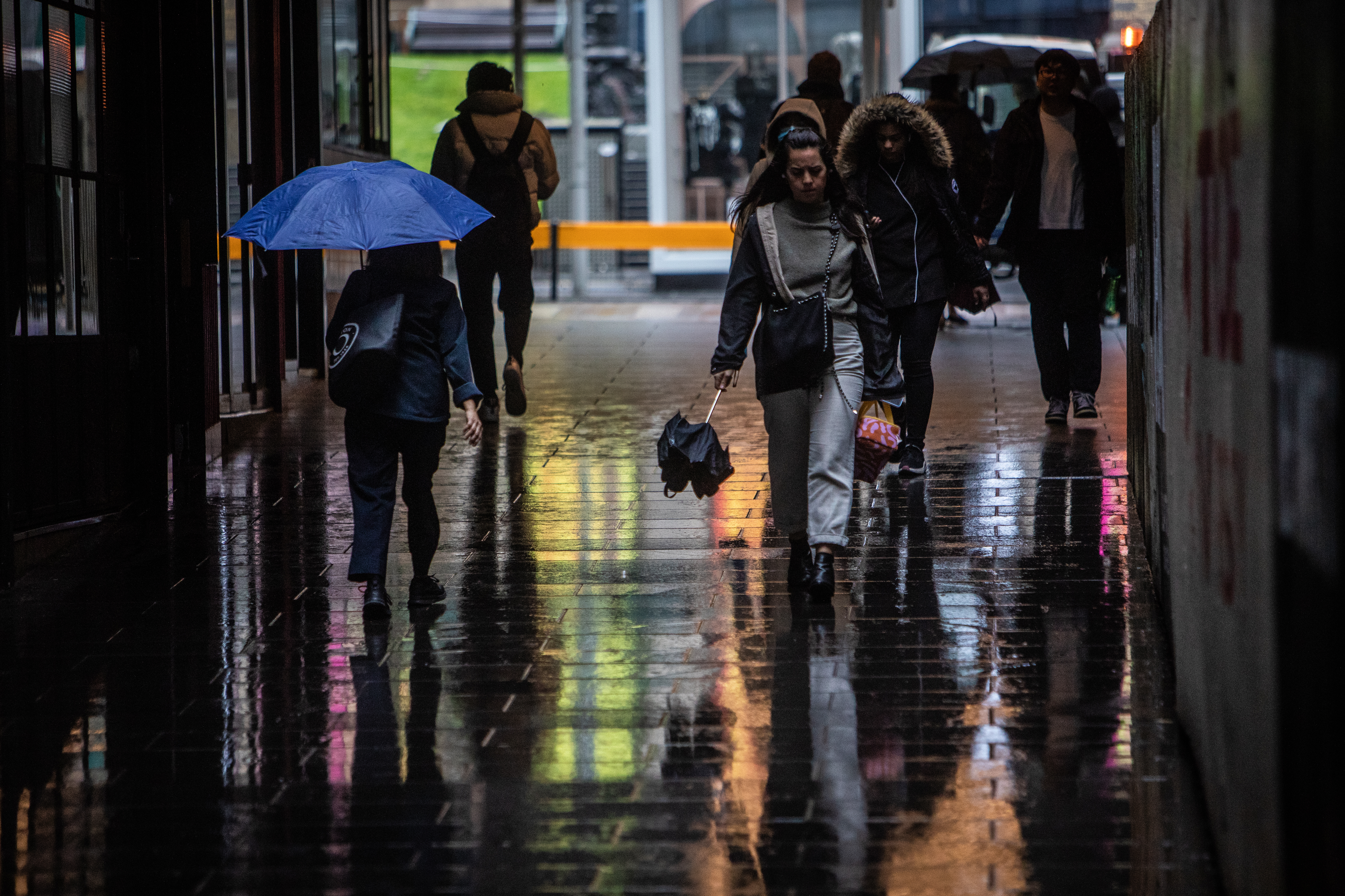 People on their way to work in Melbourne on Wednesday as the rain starts to hit. 