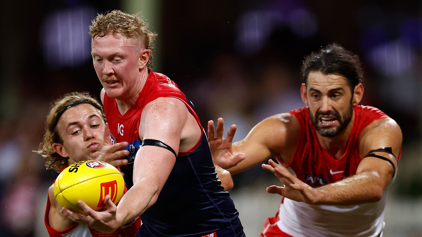 Clayton Oliver of the Demons is tackled by James Rowbottom (left) and Brodie Grundy of the Swans during the 2024 AFL Opening Round match between the Sydney Swans and the Melbourne Demons at the Sydney Cricket Ground on March 07, 2024 in Sydney, Australia. (Photo by Michael Willson/AFL Photos via Getty Images)