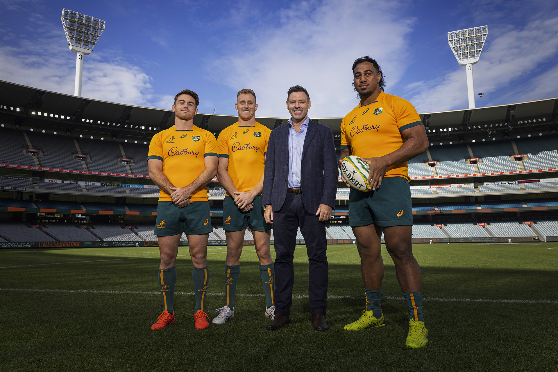 Wallabies players (from left) Andrew Kellaway, Reece Hodge, Melbourne Rebels CEO Baden Stephenson, and Pone Fa'amausili pose at the Melbourne Cricket Ground.