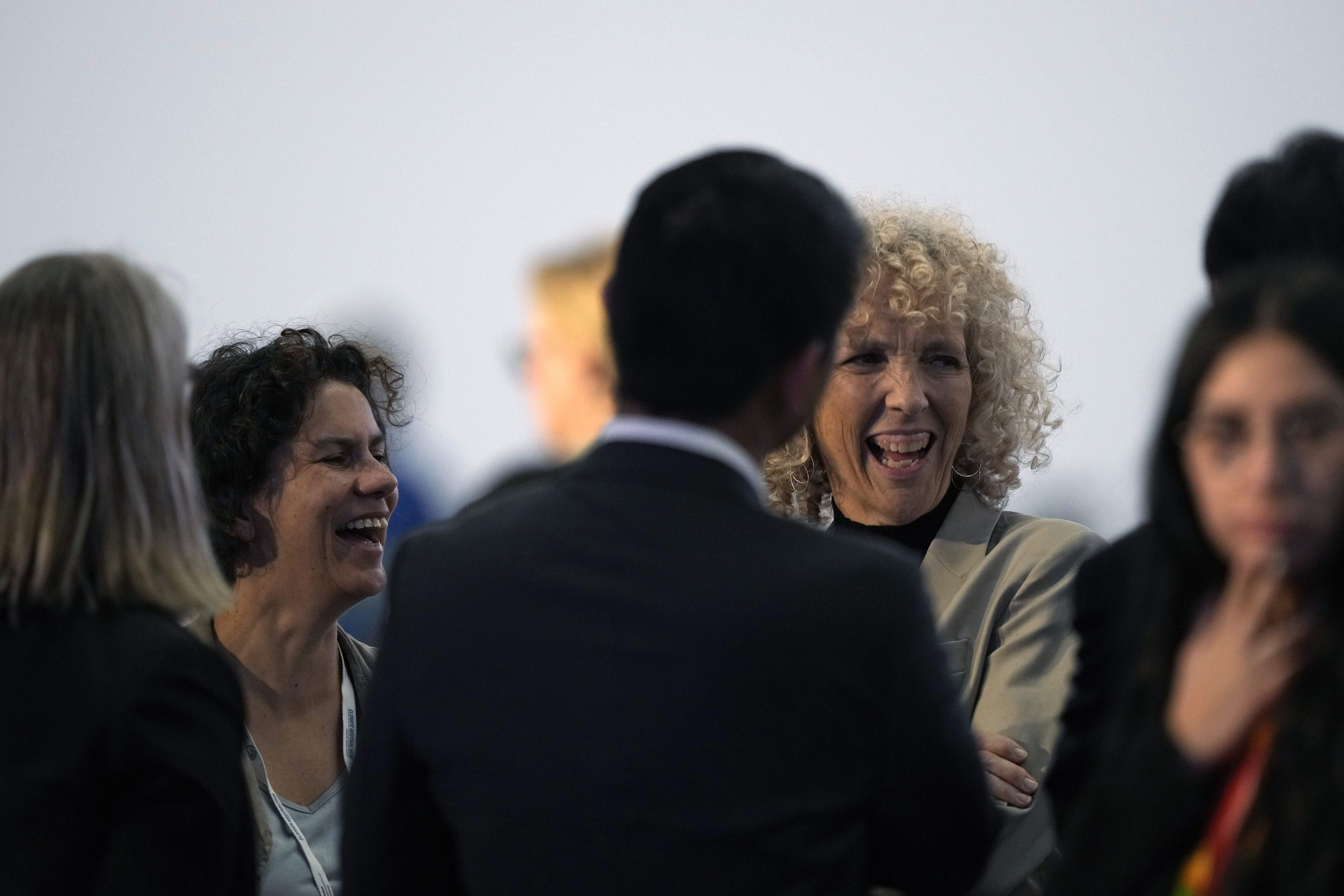 Maisa Rojas, minister of environment of Chile, left, and Germany's climate envoy Jennifer Morgan laugh ahead of a closing plenary session at the COP27 U.N. Climate Summit, Sunday, Nov. 20, 2022, in Sharm el-Sheikh, Egypt. (AP Photo/Peter Dejong)
