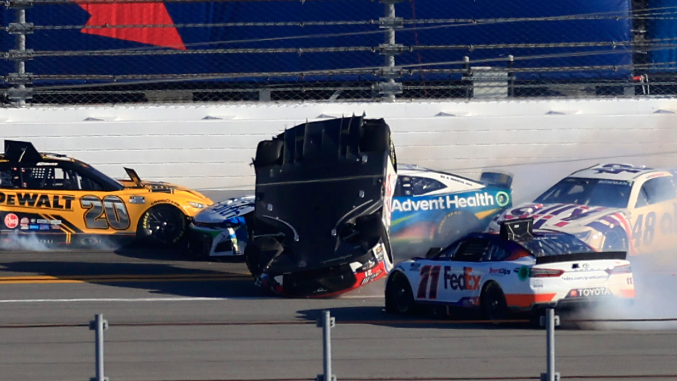 Harrison Burton, driver of the #21 Motorcraft/DEX Imaging Ford, flips after an on-track incident with Denny Hamlin, driver of the #11 FedEx Express Toyota, Ross Chastain, driver of the #1 Advent Health Chevrolet, and Kyle Busch, driver of the #18 M&M's Toyota, during the NASCAR Cup Series 64th Annual Daytona 500 at Daytona International Speedway