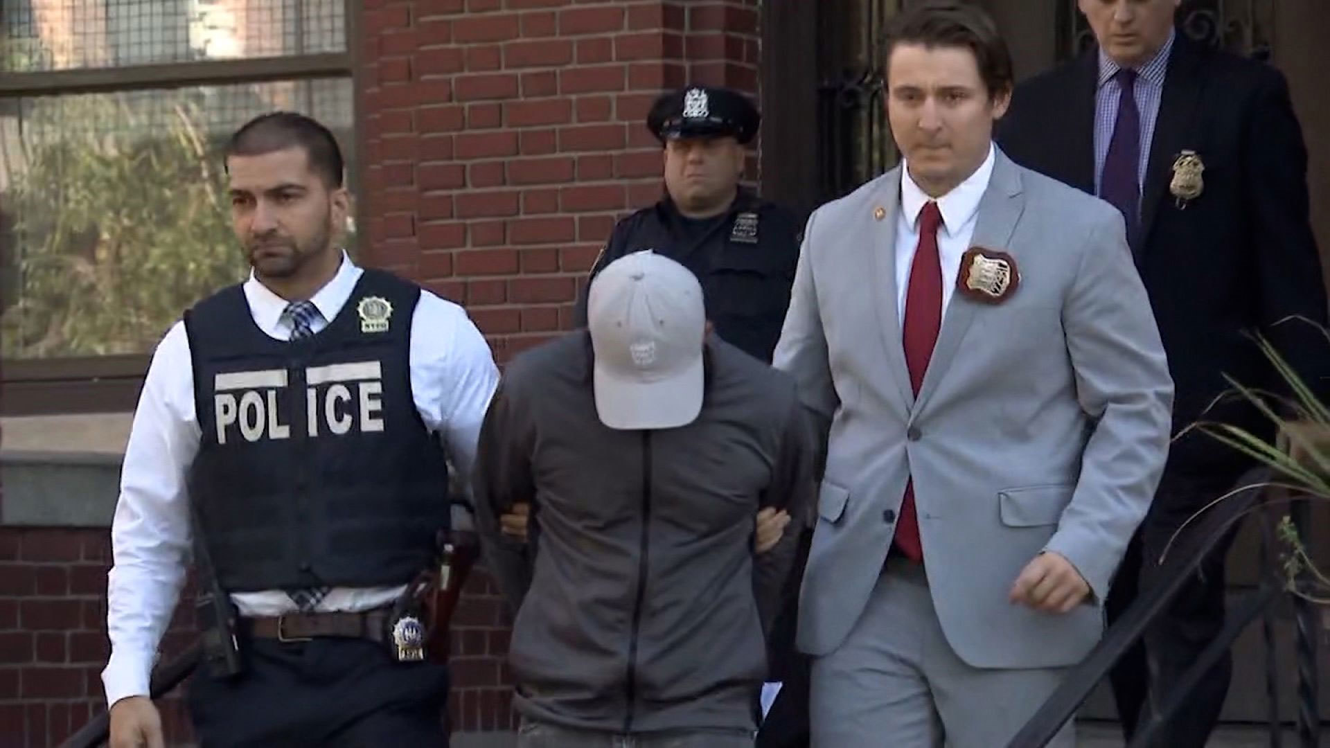 Carlisto Acevedo Brito, with his head down, has been charged in connection with the overdose death of a 1-year-old boy and the hospitalization of three other children.